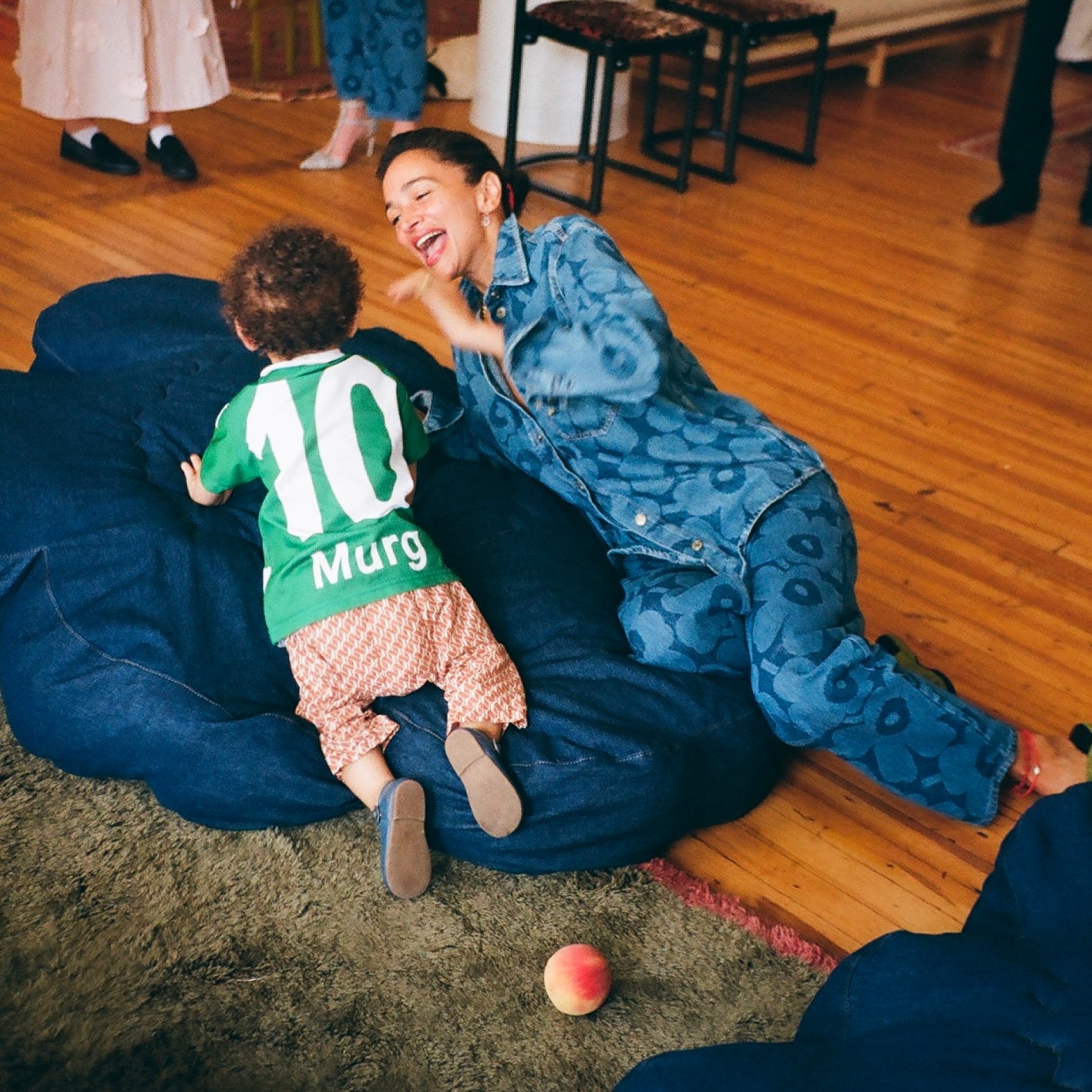 Laila Gohar and the child on a huge denim Unikko seat cushion