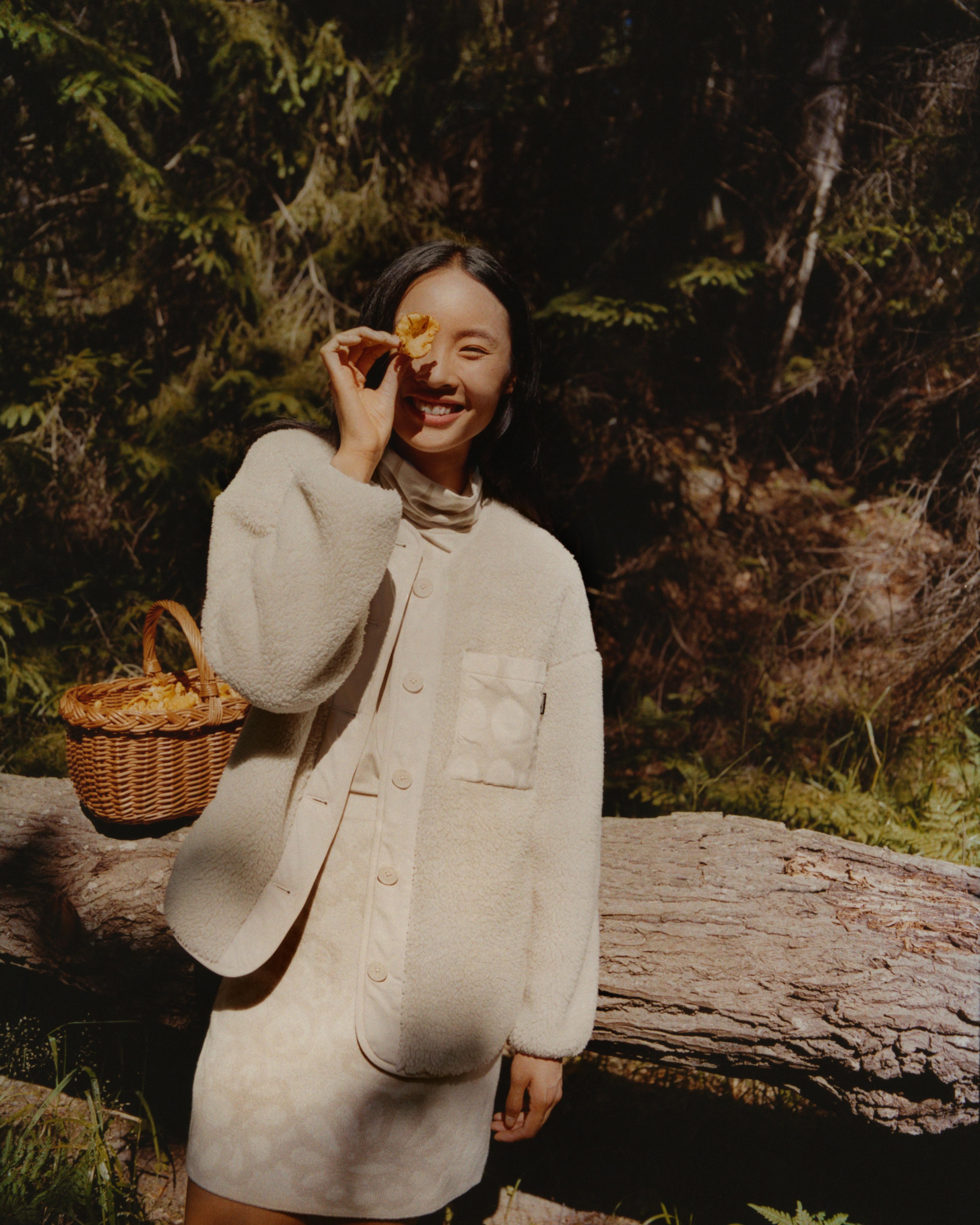 Model wearing Uniqlo and Marimekko collaboration jacket and dress in light colors