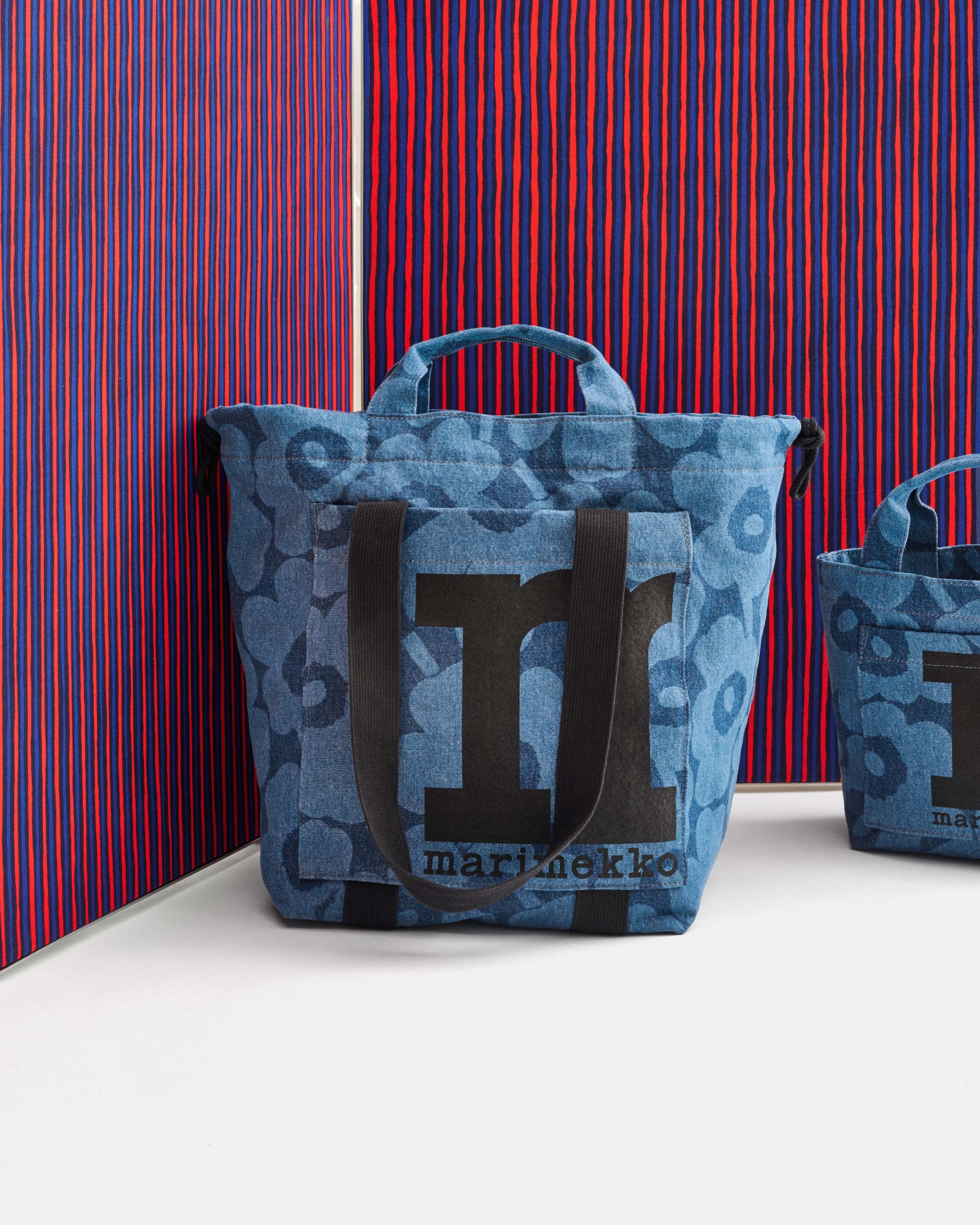 Denim fabric bag with Unikko print, pictured against blue-red Piccolo fabric.