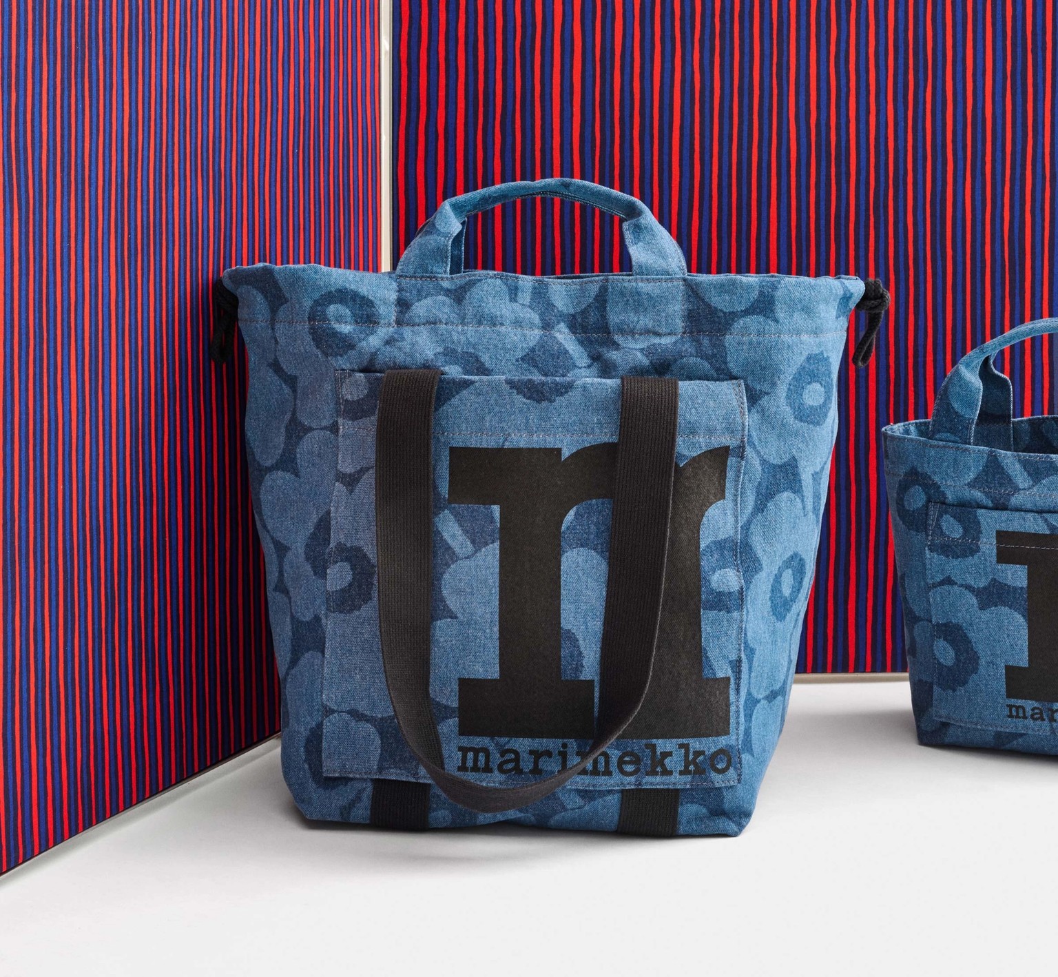 Denim fabric bag with Unikko print, pictured against blue-red Piccolo fabric.