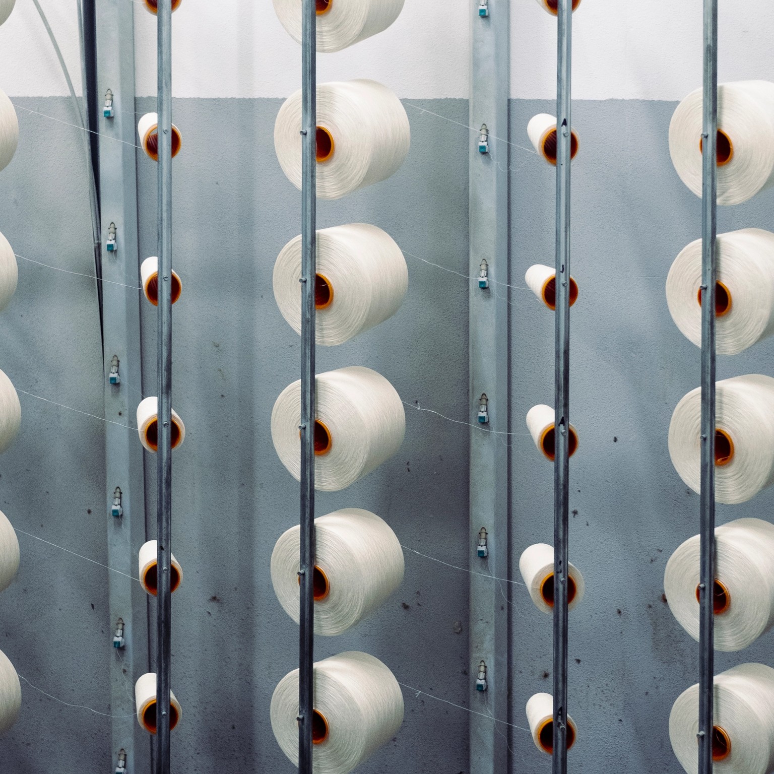 Spools of yarn in a production machine.