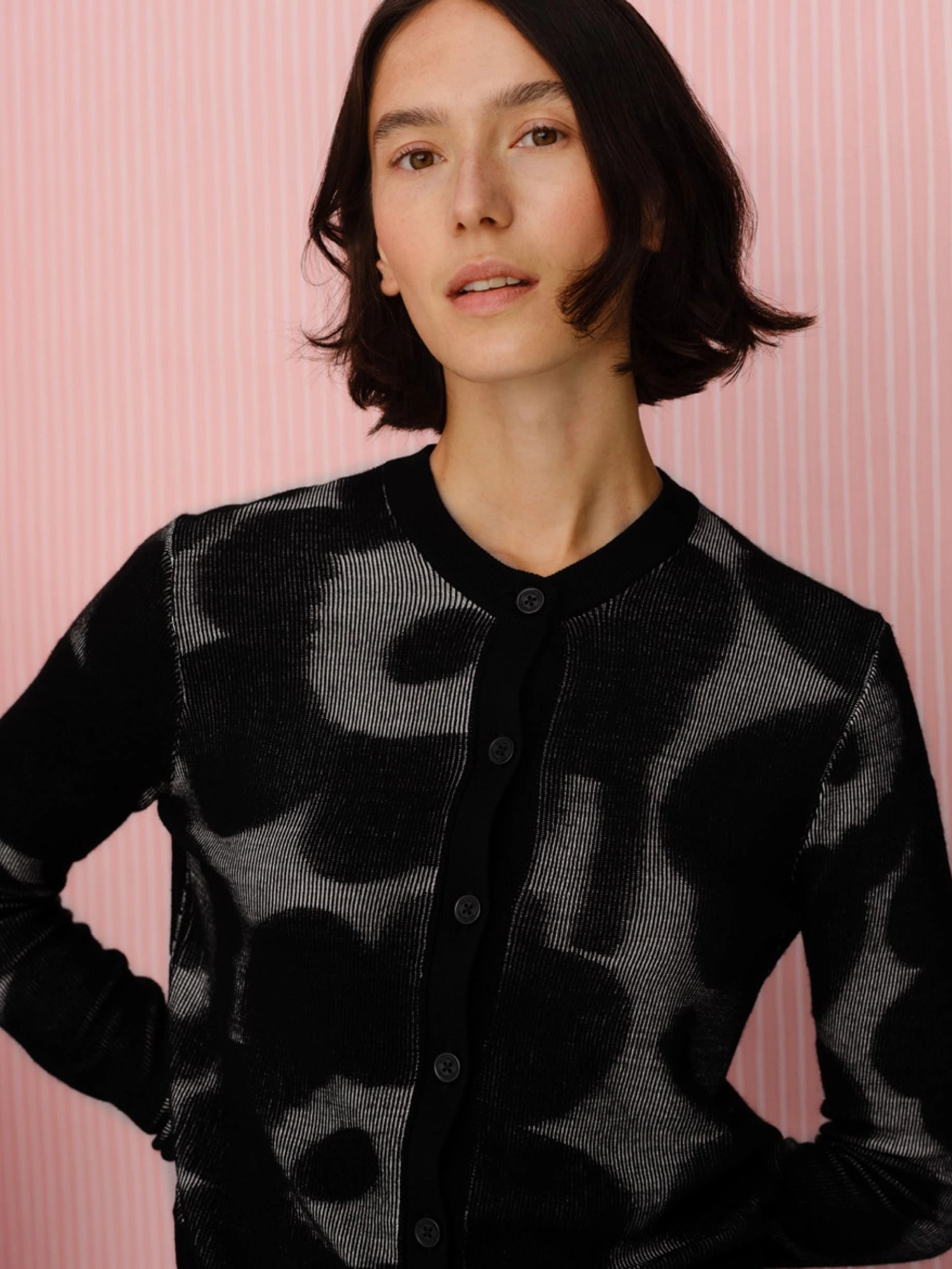 The models are wearing a Unikko sweater and a Ladonta jacket in Unikko pattern in two different pictures.