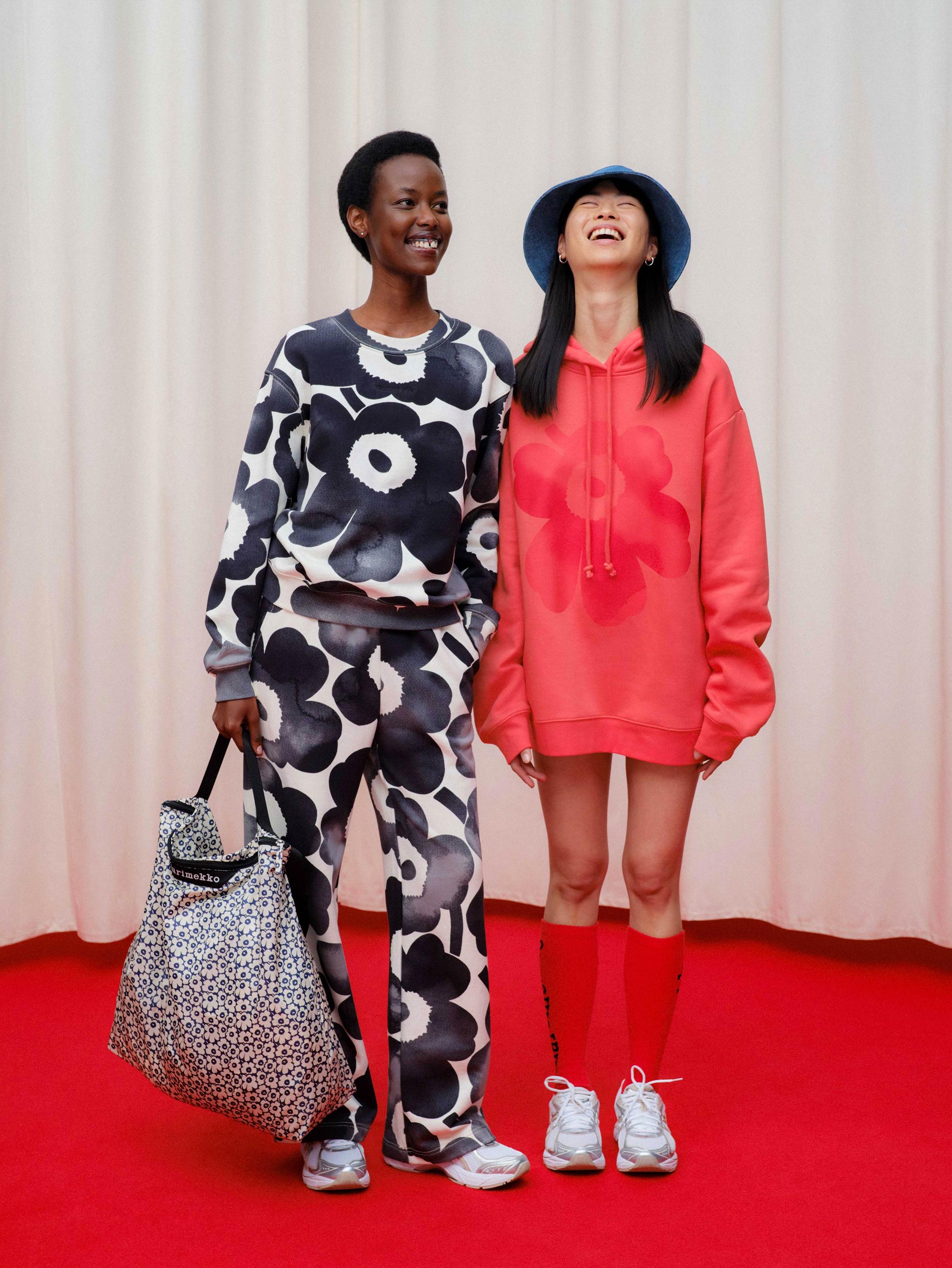 Models wearing sweatshirt and sweatpants in Unikko pattern and a red Runoja hoodie.