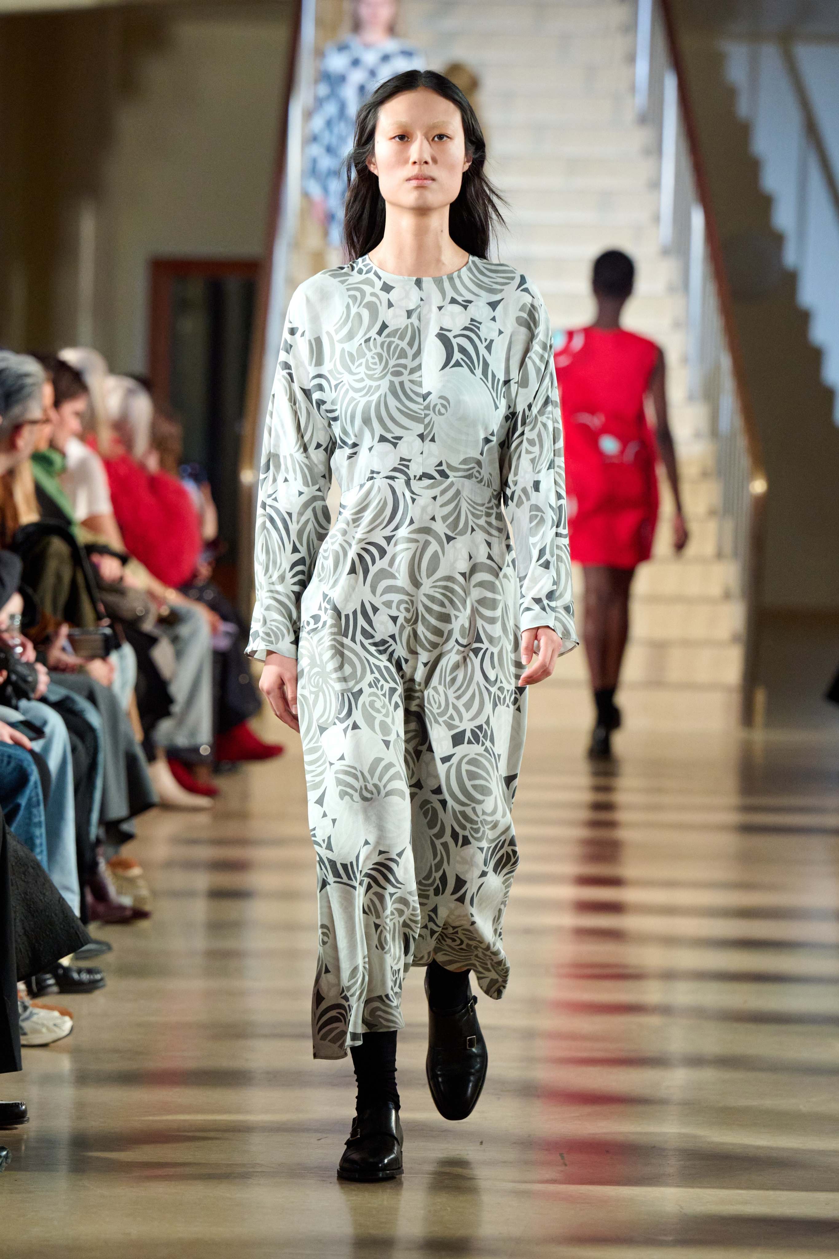 Model wearing grey dress in flower print.