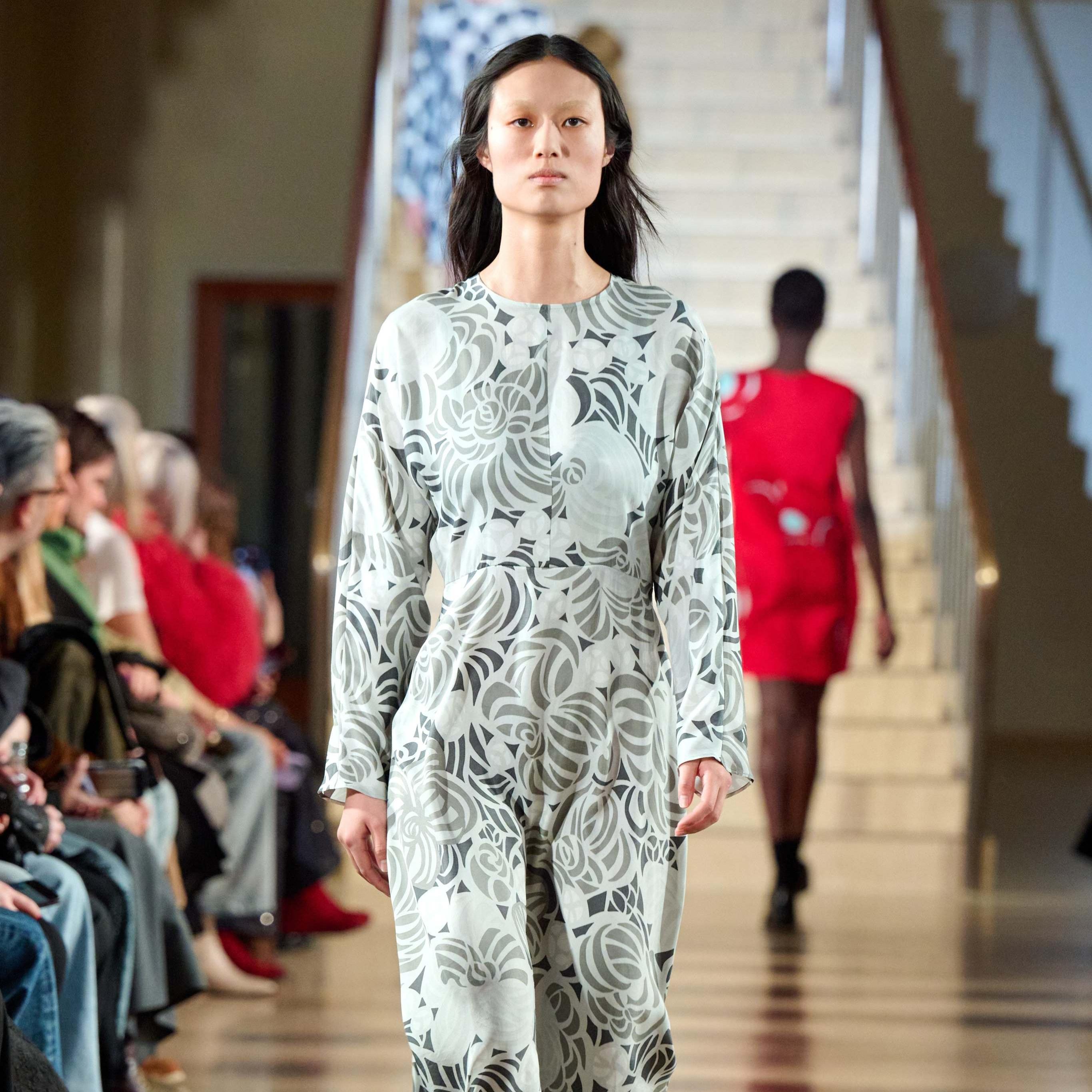Model wearing grey dress in flower print.