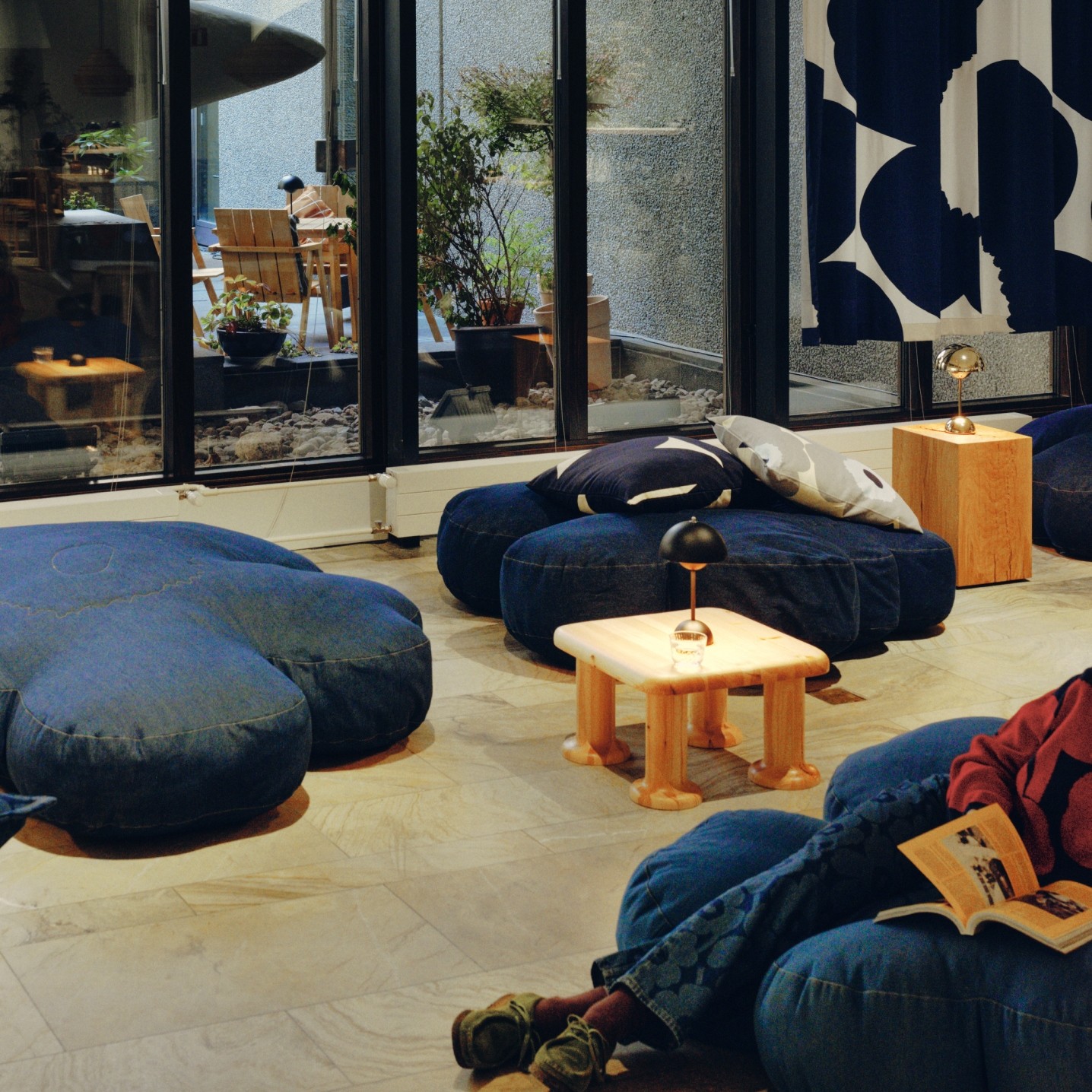 Bar Unikko's interior is decorated with large denim Unikko seat cushions, a blue and white Unikko patterned curtain and Marimekko's decorative cushions