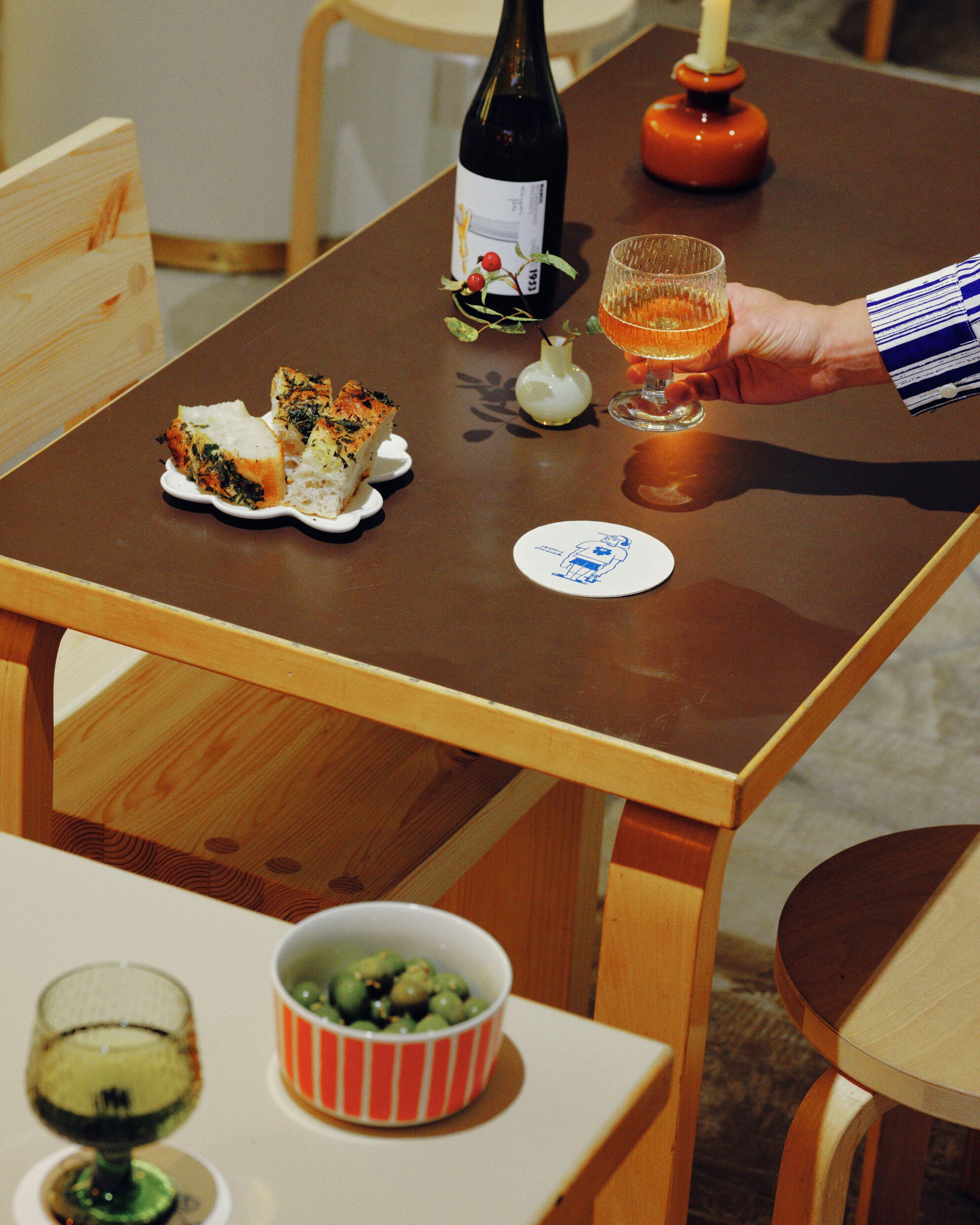 Foccacia, wine and olives served in Marimekko dishes