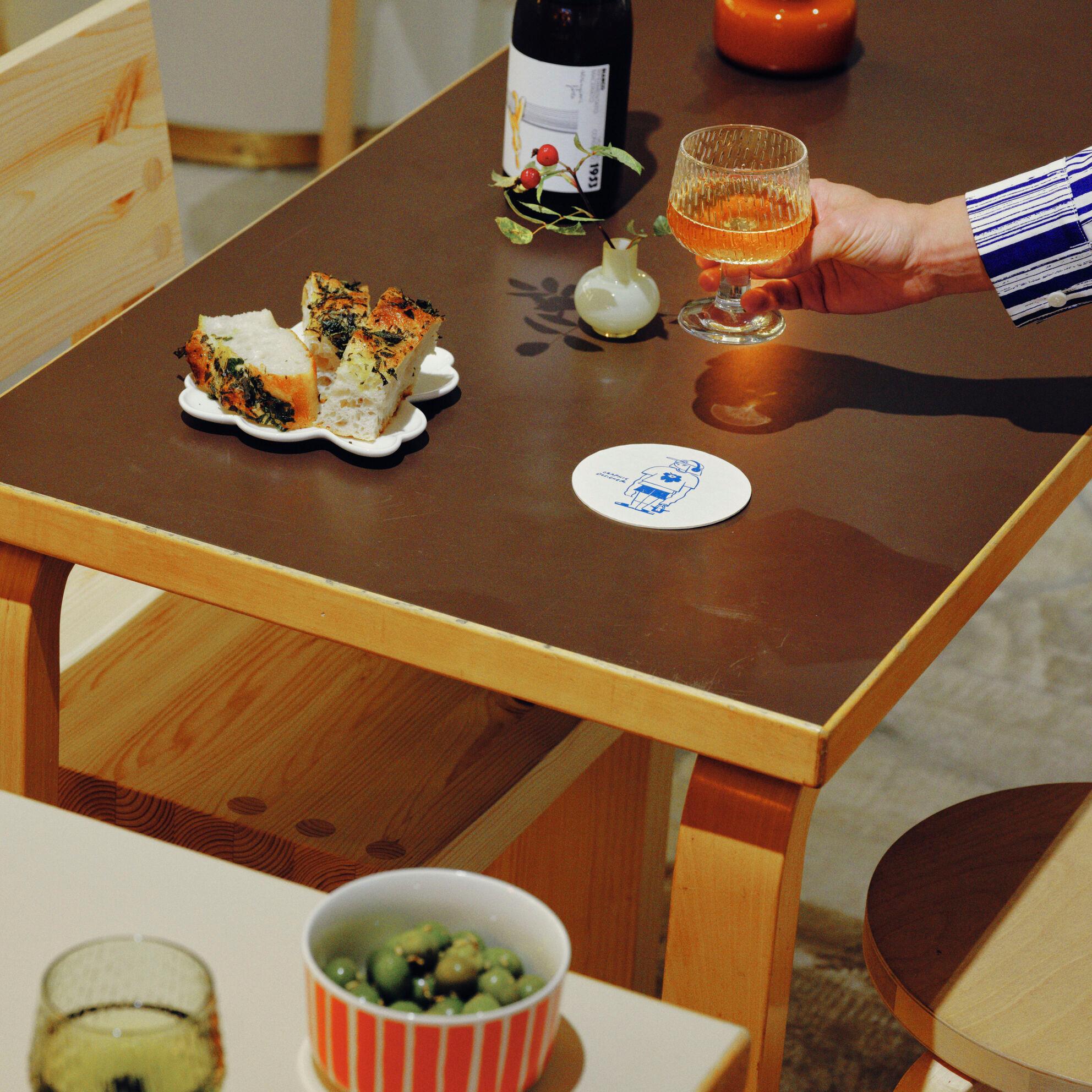 Foccacia, wine and olives served in Marimekko dishes
