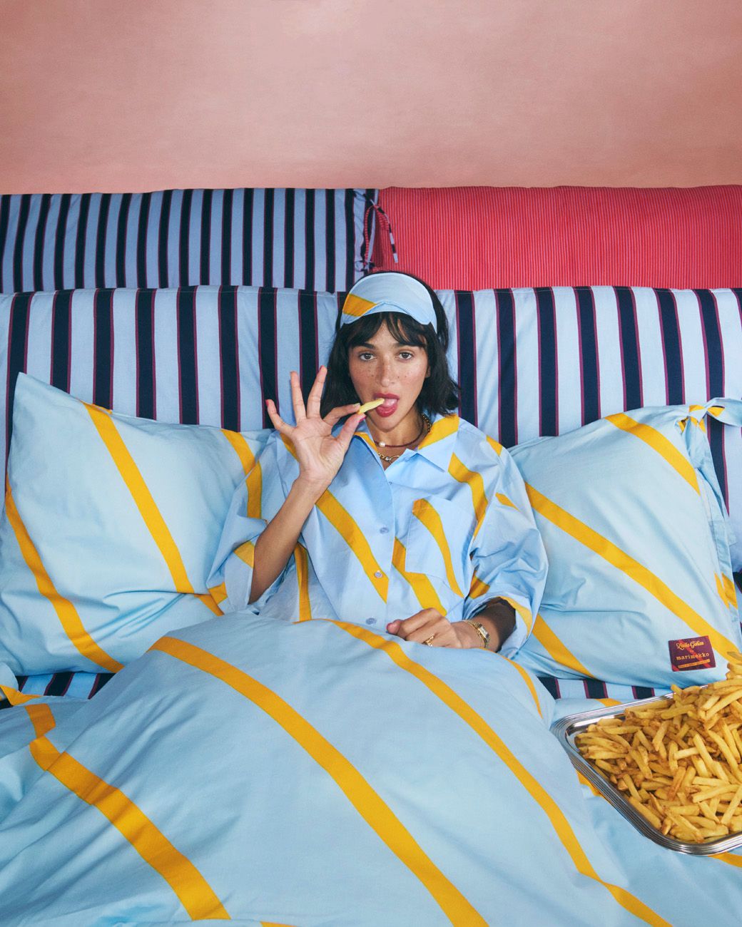 Laila Gohar in pyjamas eating french fries