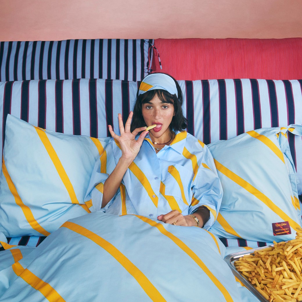Laila Gohar in pyjamas eating french fries