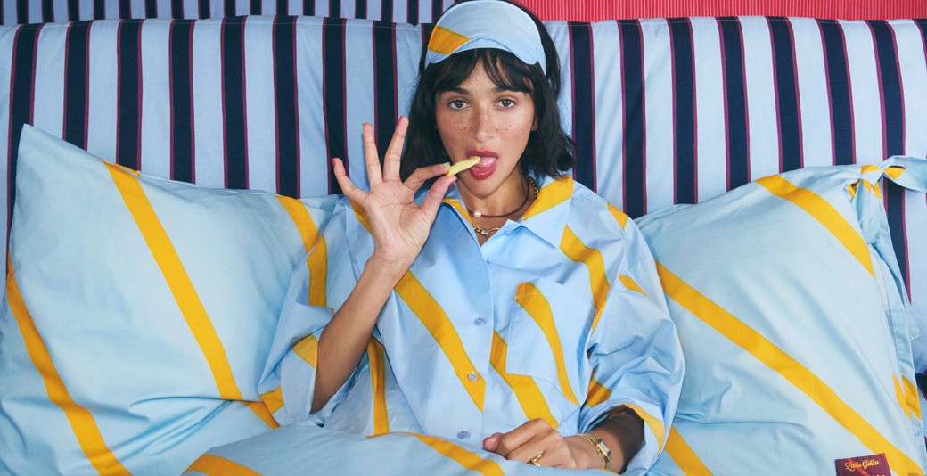 Laila Gohar in pyjamas eating french fries