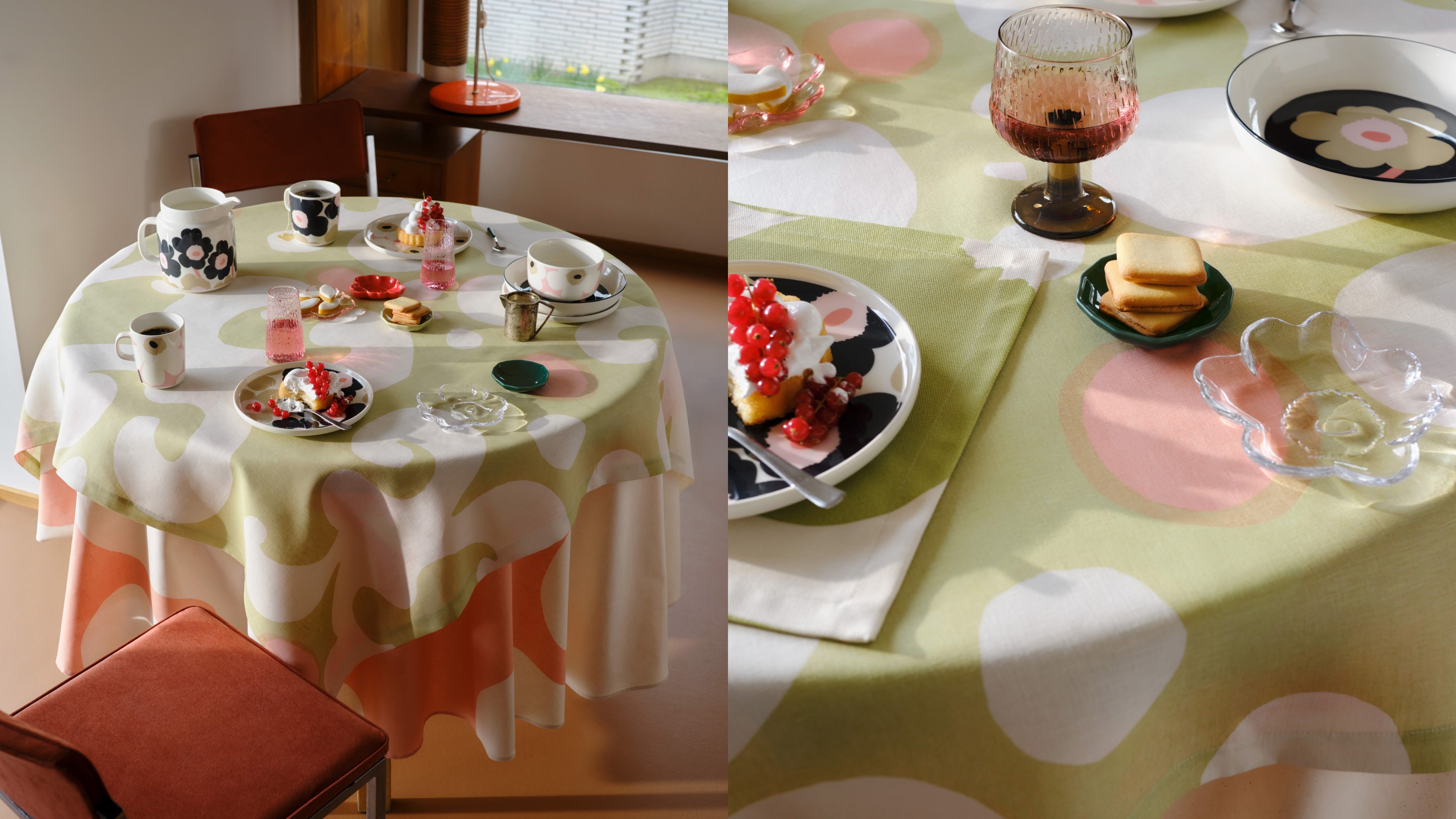 A set table with dishes and a light green Keidas fabric tablecloth.