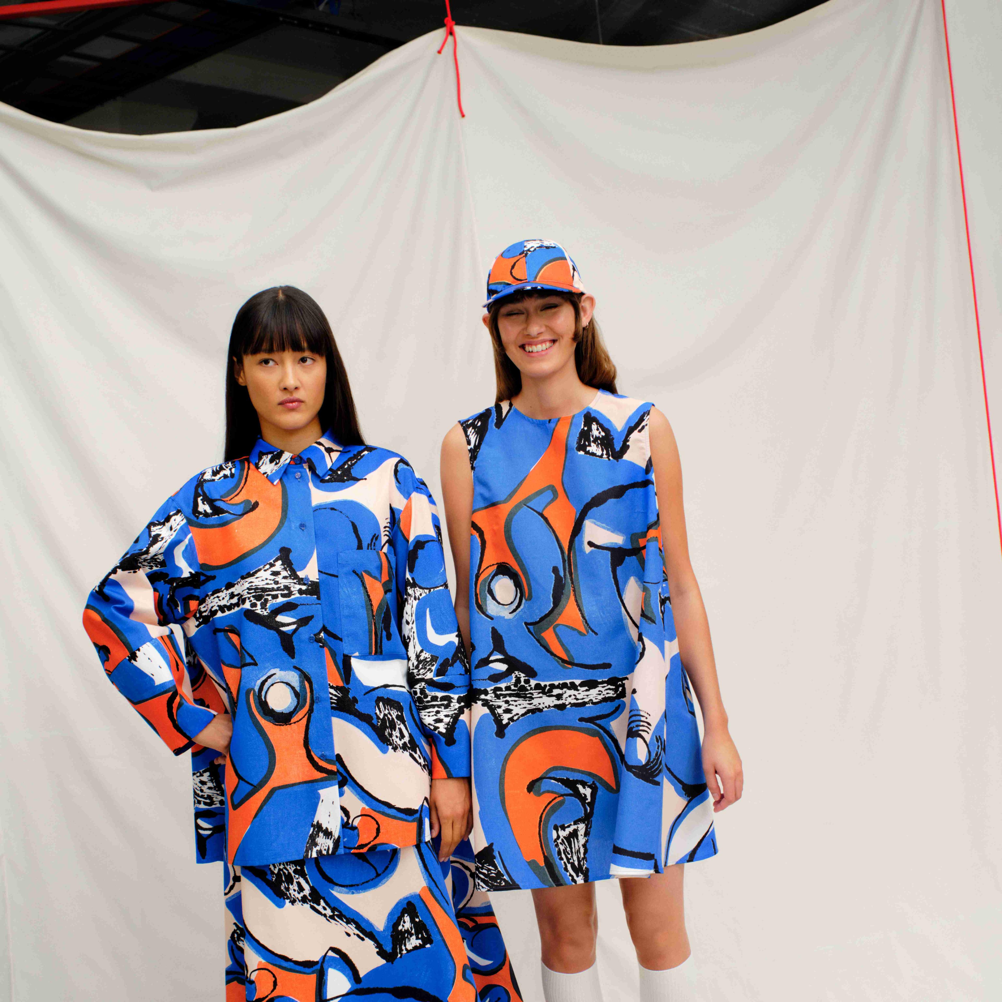 Models dressed in the Petra Börner collaboration collection Kukkavera Eldfamn shirt jacket with skirt, dress and cap.