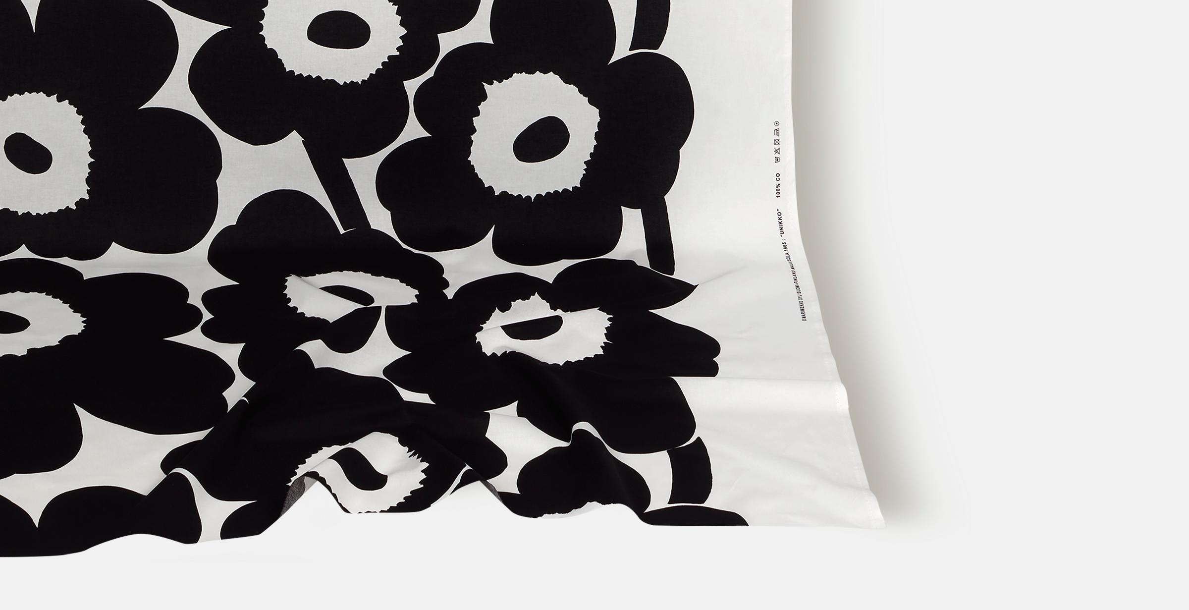 Fabric with black and white Unikko pattern.