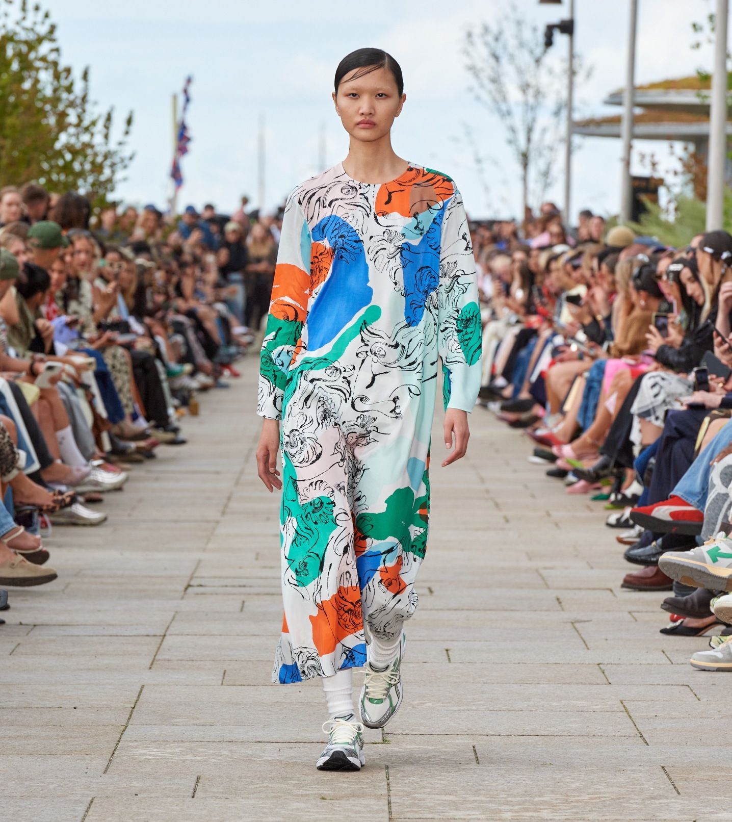 Model walking on the catwalk of the fashion show dressed in Fluidi Blombom dress.
