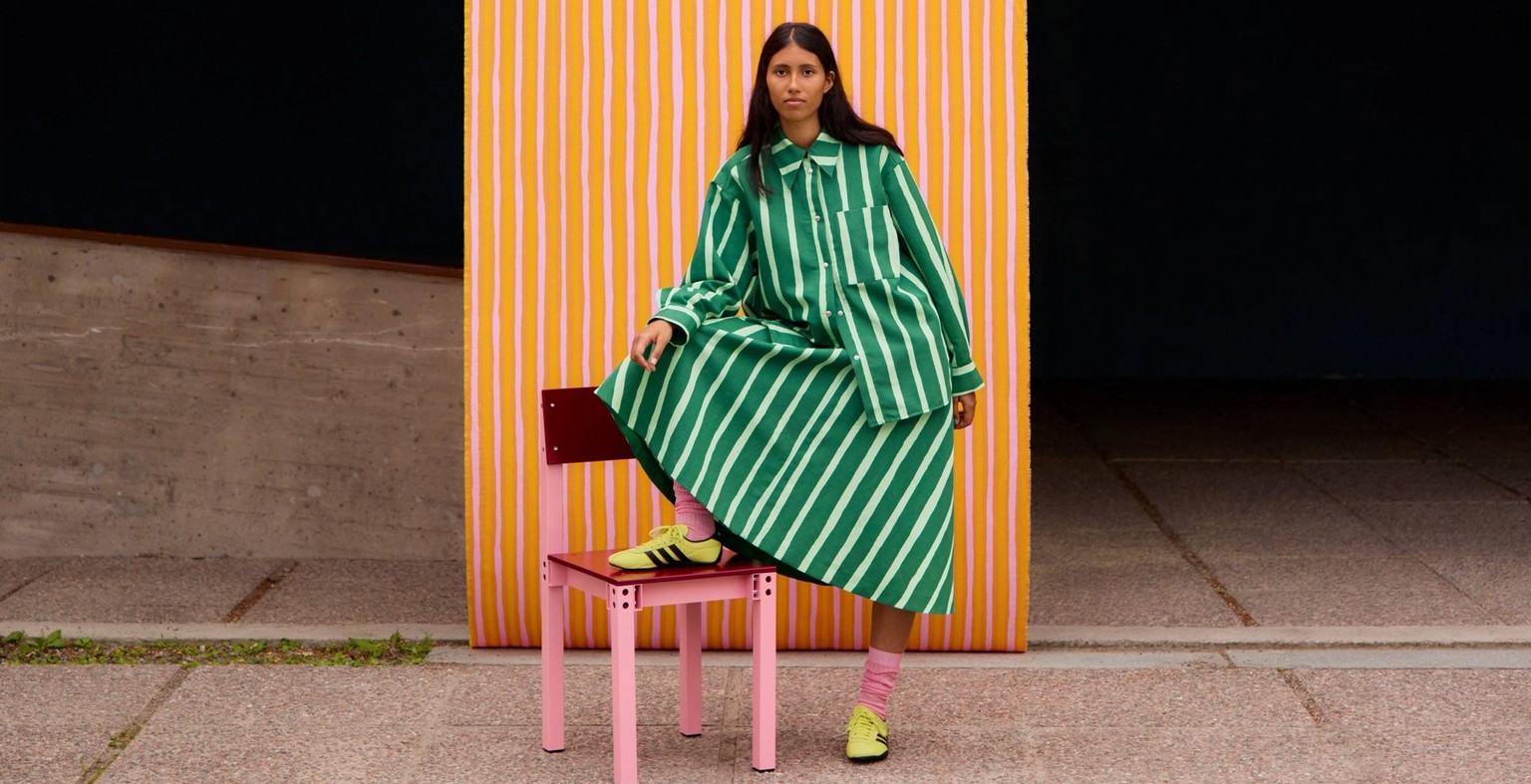 Model wearing a shirt and skirt set in green Piccolo print.