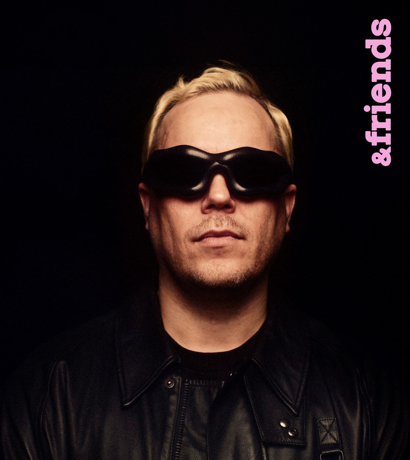 A portrait of a man wearing sunglasses (Karri Koira) with a vertical text ''Marimekko'' in the top right corner.