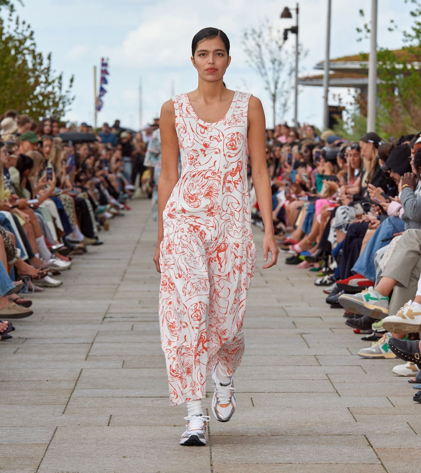 Model walking on the catwalk of the fashion show dressed in a Taide Cactis dress.