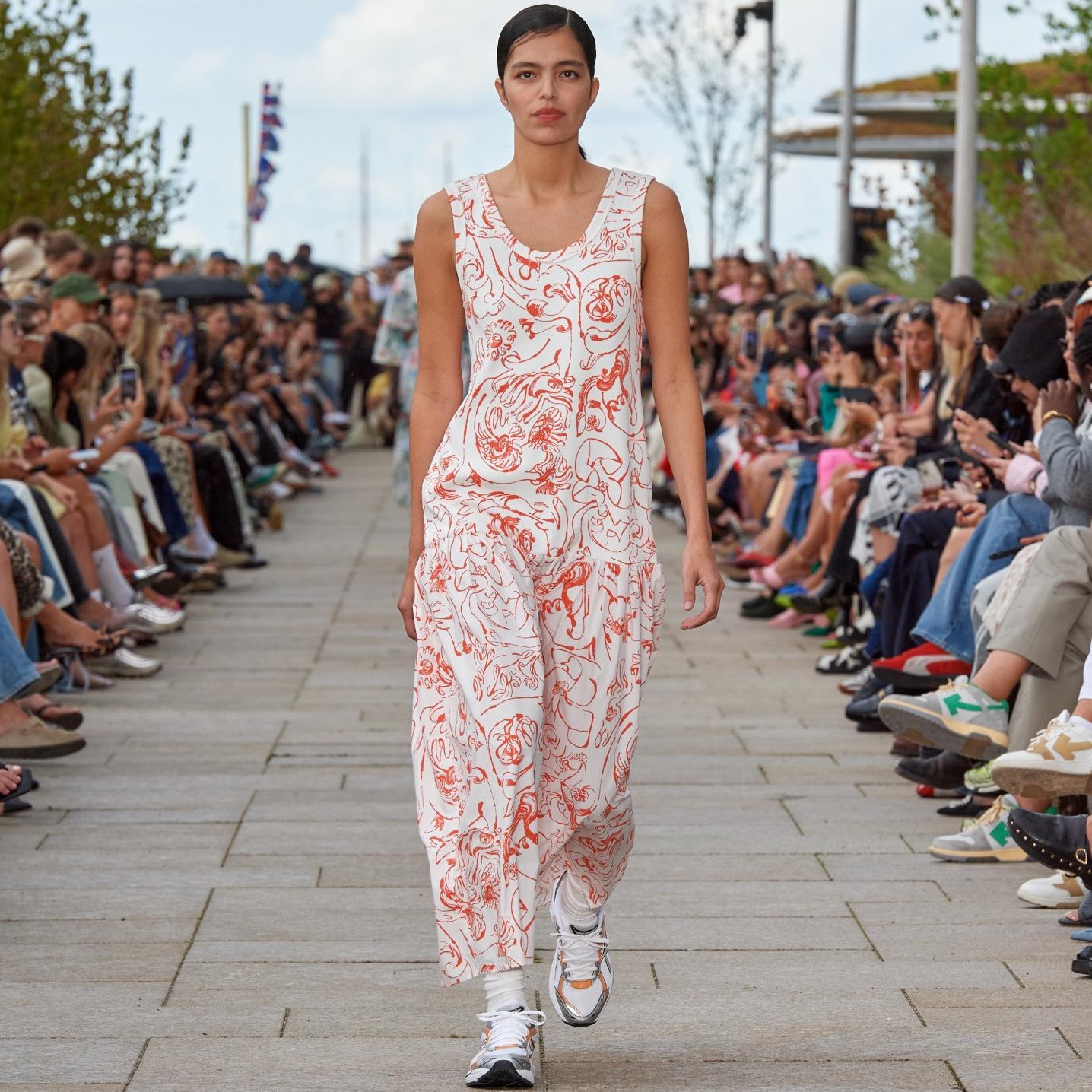 Model walking on the catwalk of the fashion show dressed in a Taide Cactis dress.