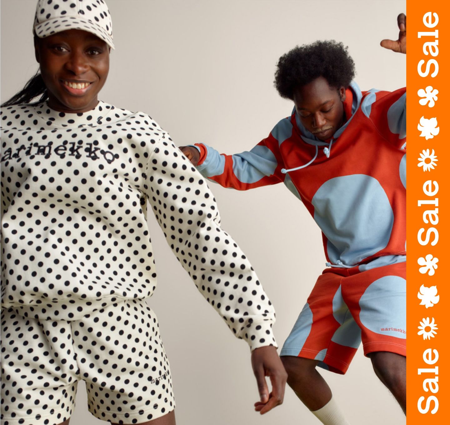Two happy models jumping and wearing Marimekko Kioski sets in Pallo and Klaava prints.