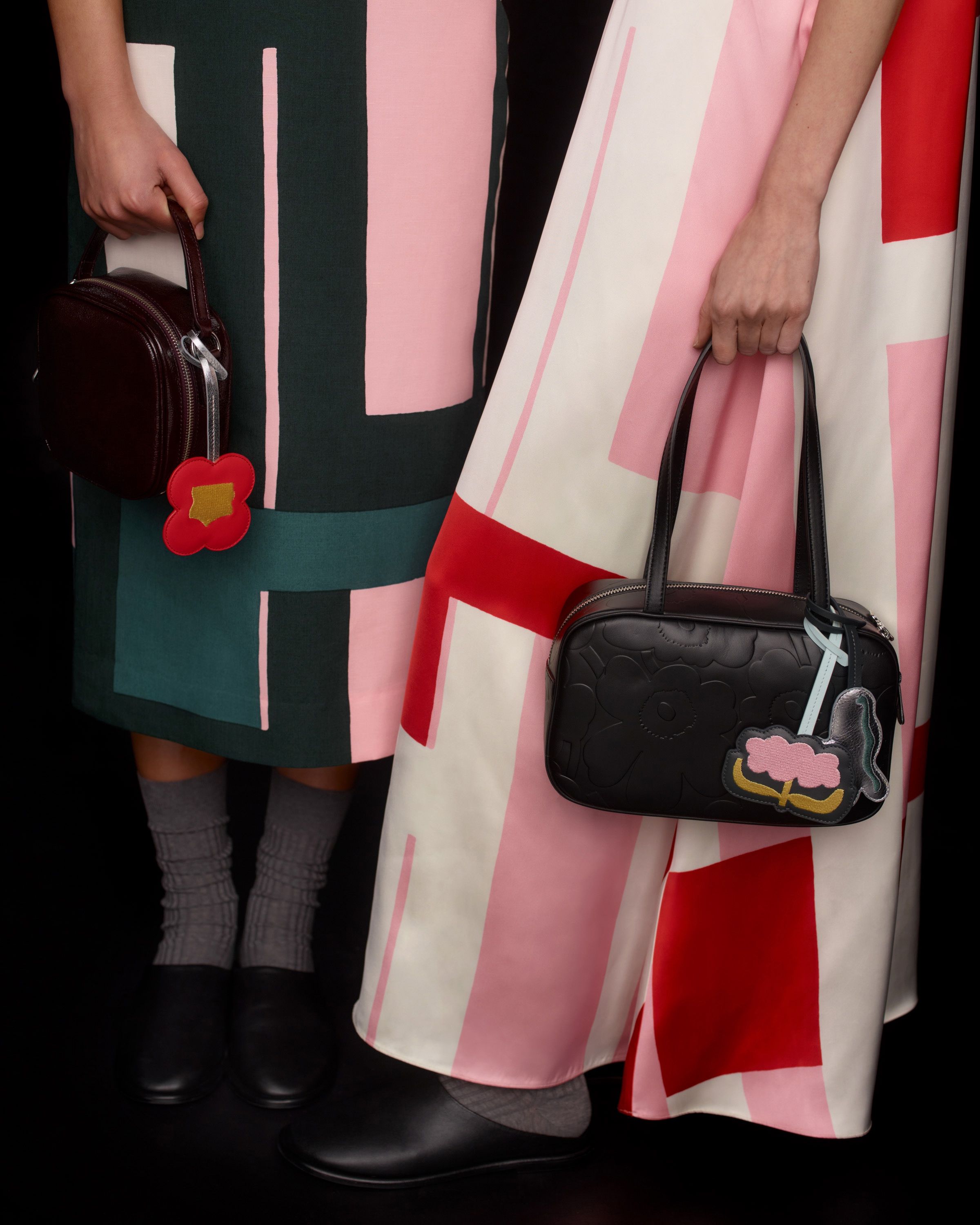 Two models carrying black Marimekko Gratha leather bags.