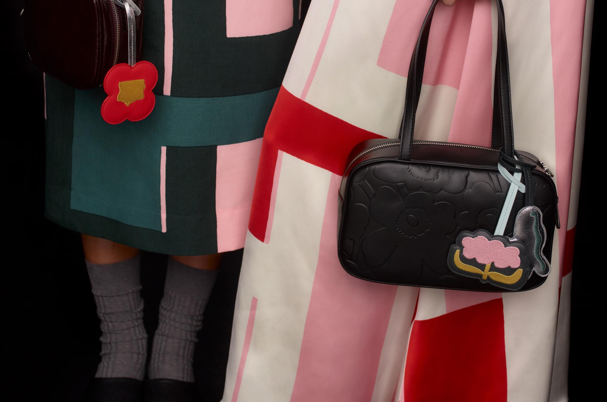 Two models carrying black Marimekko Gratha leather bags.