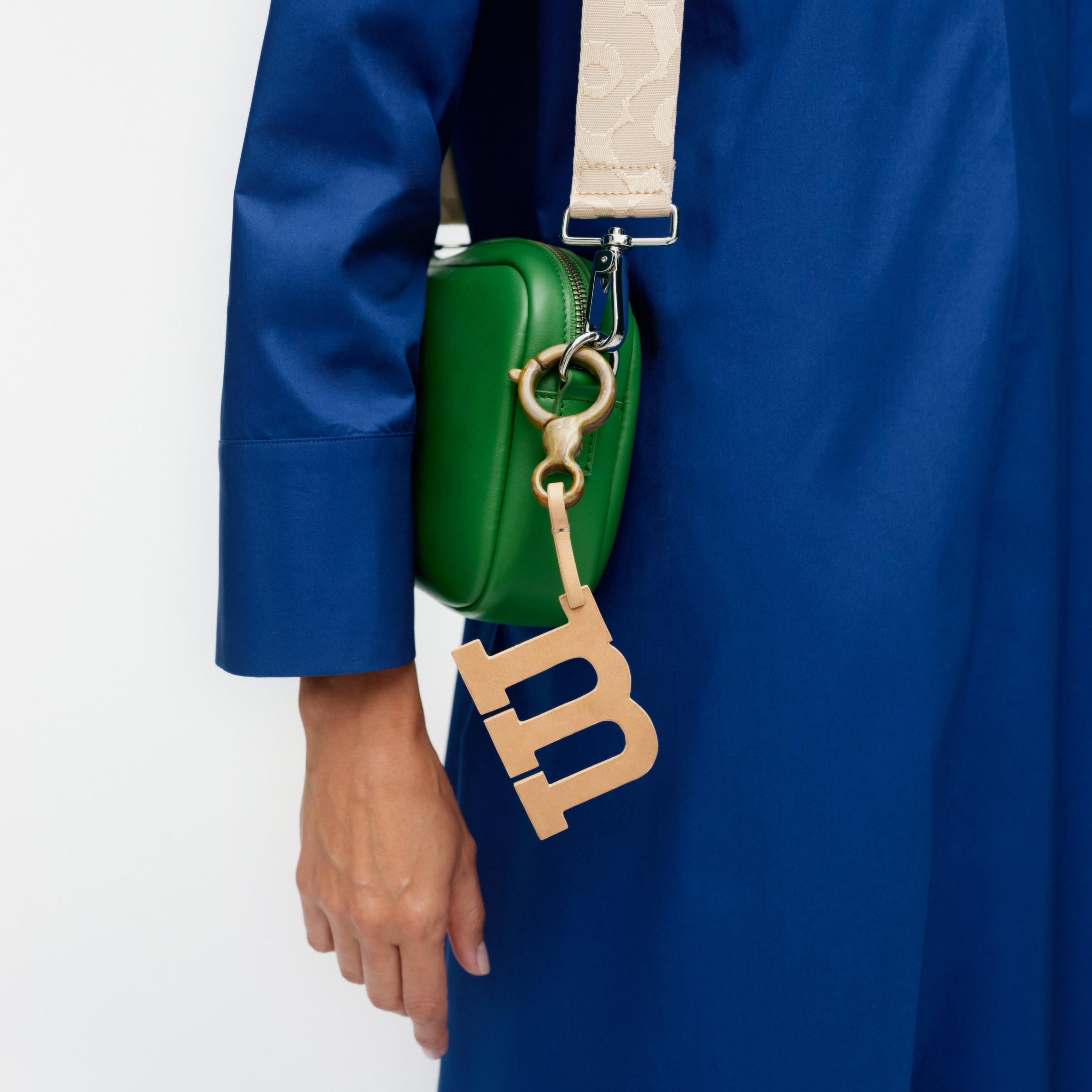 Beige M-shaped charm.