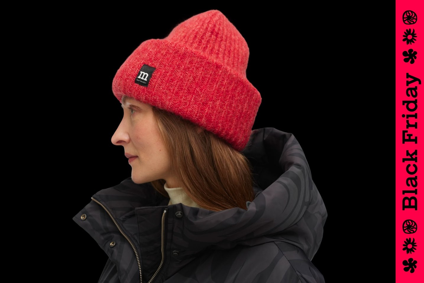 Model wearing a red beanie and Black Friday text on the side.