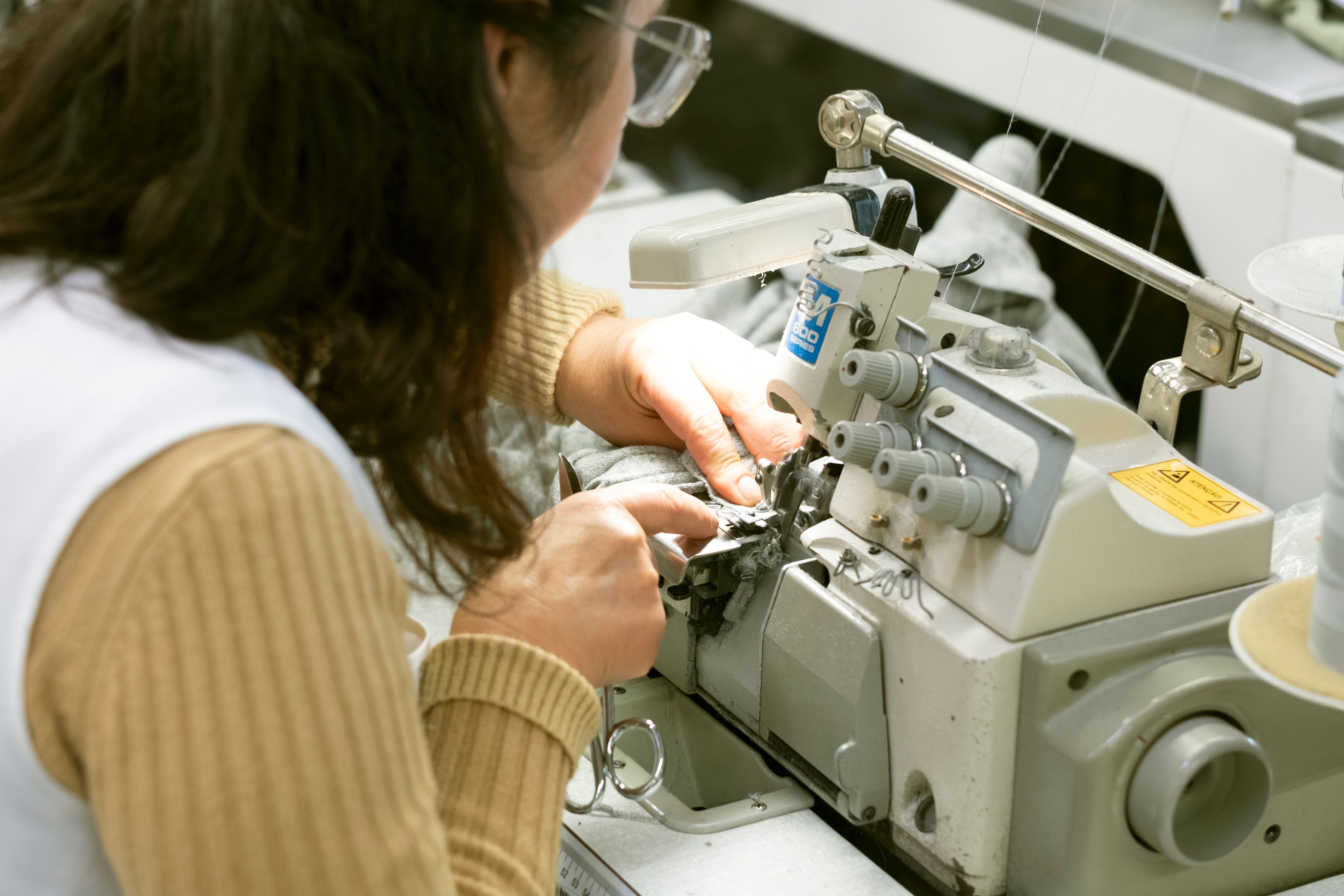 A dressmaker sewing with a sewing machine.