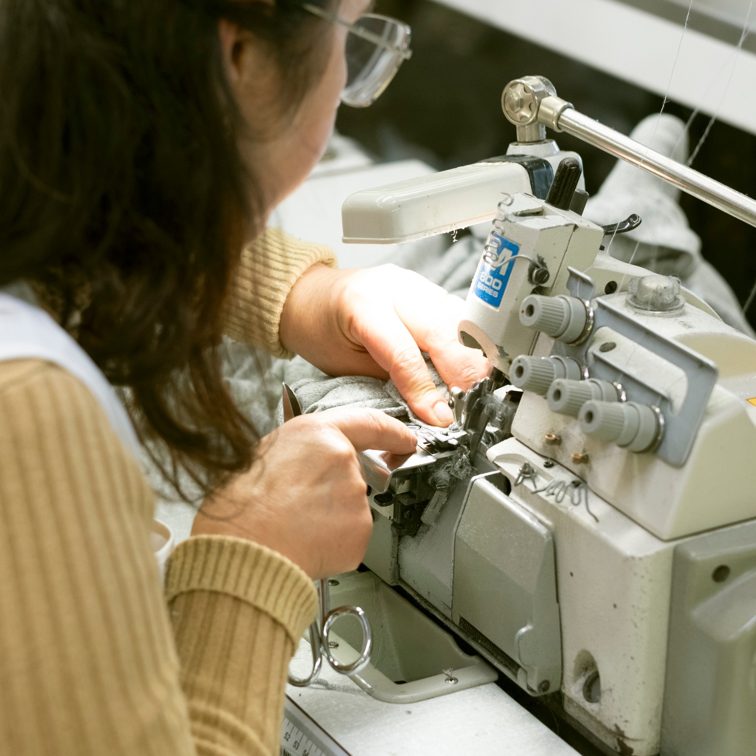 A dressmaker sewing with a sewing machine.