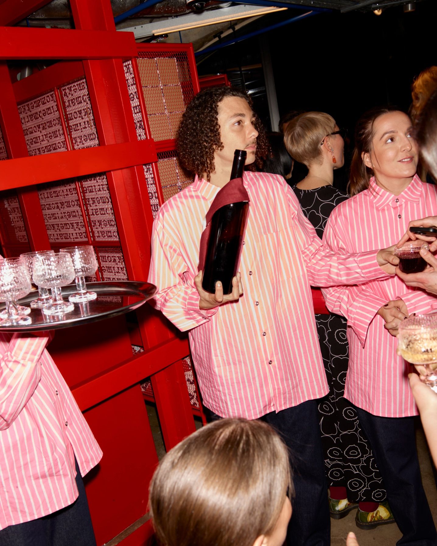 Staff serving bubbles to guests at the Marimekko Paris store opening.