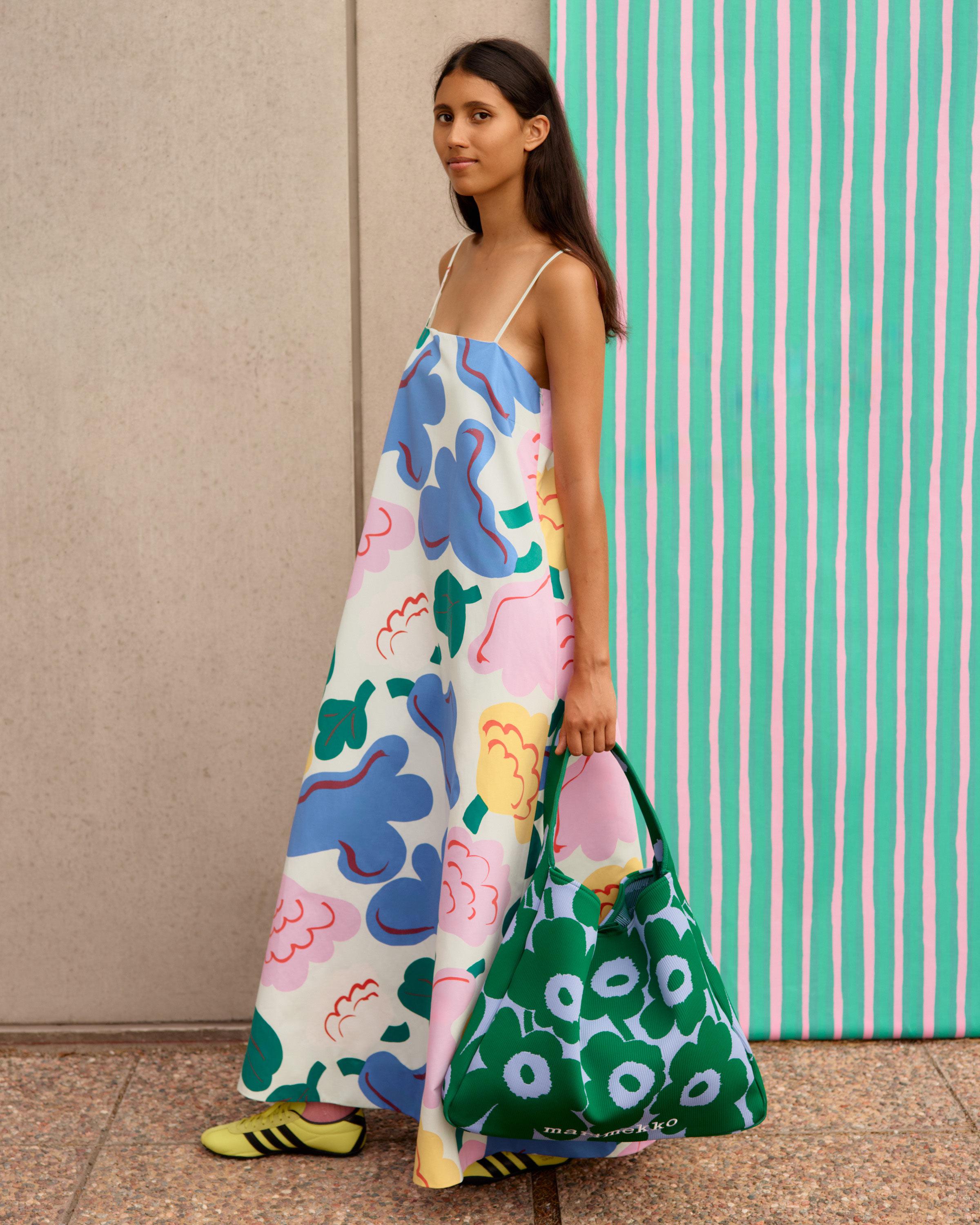 Model wearing a dress in Kukasta Kukkaan pattern.