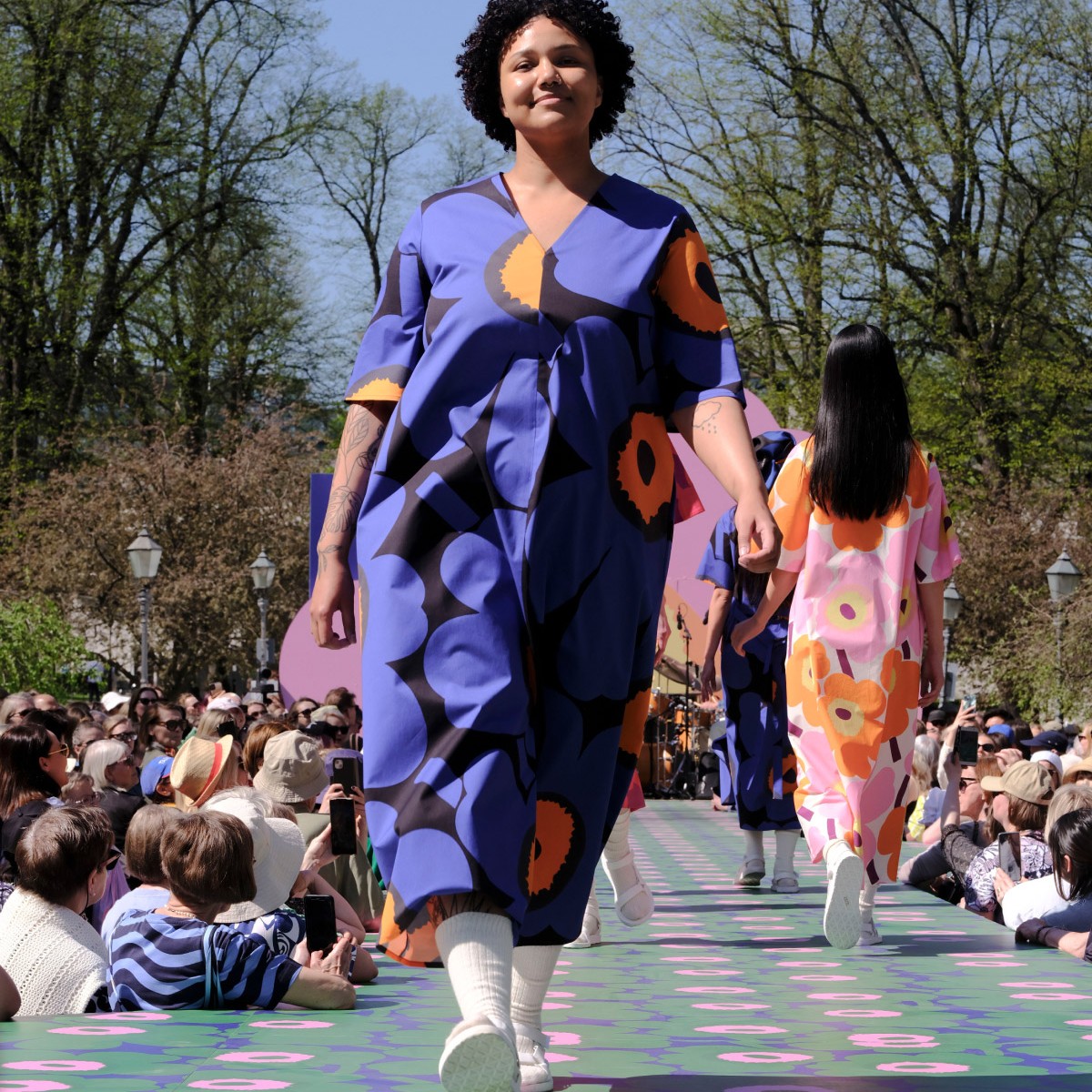 Model wearing Unikko 60th anniversary dress in blue color.