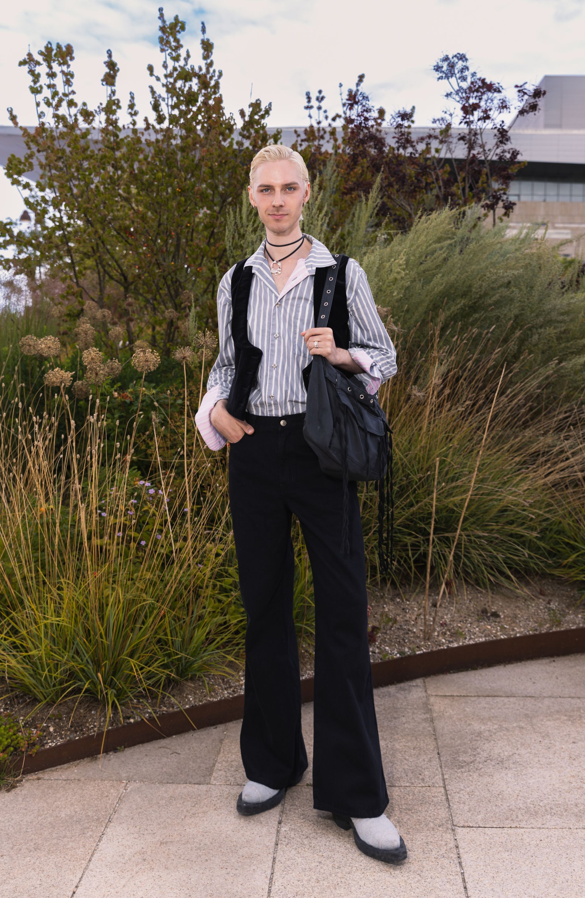 Mikko Puttonen dressed in black wide-leg Maridenim jeans and a gray Jokapoika shirt