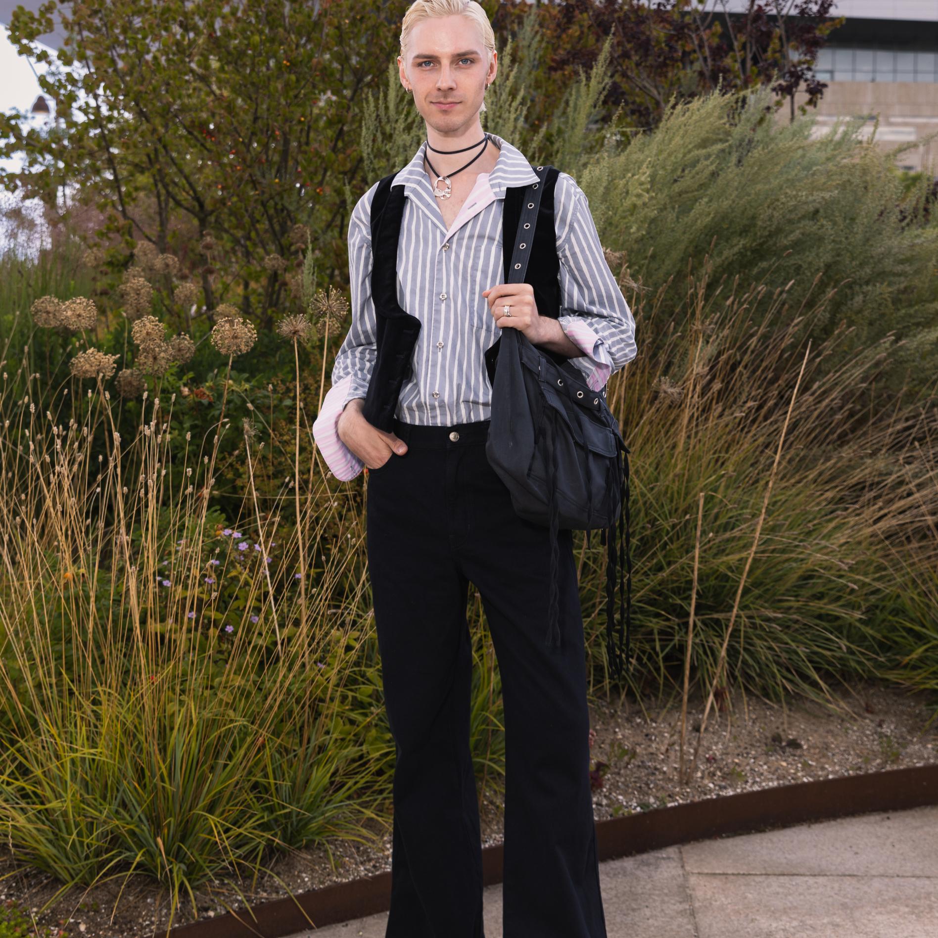 Mikko Puttonen dressed in black wide-leg Maridenim jeans and a gray Jokapoika shirt