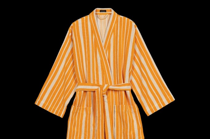 Keltainen Raide-kylpytakki mustalla taustalla.