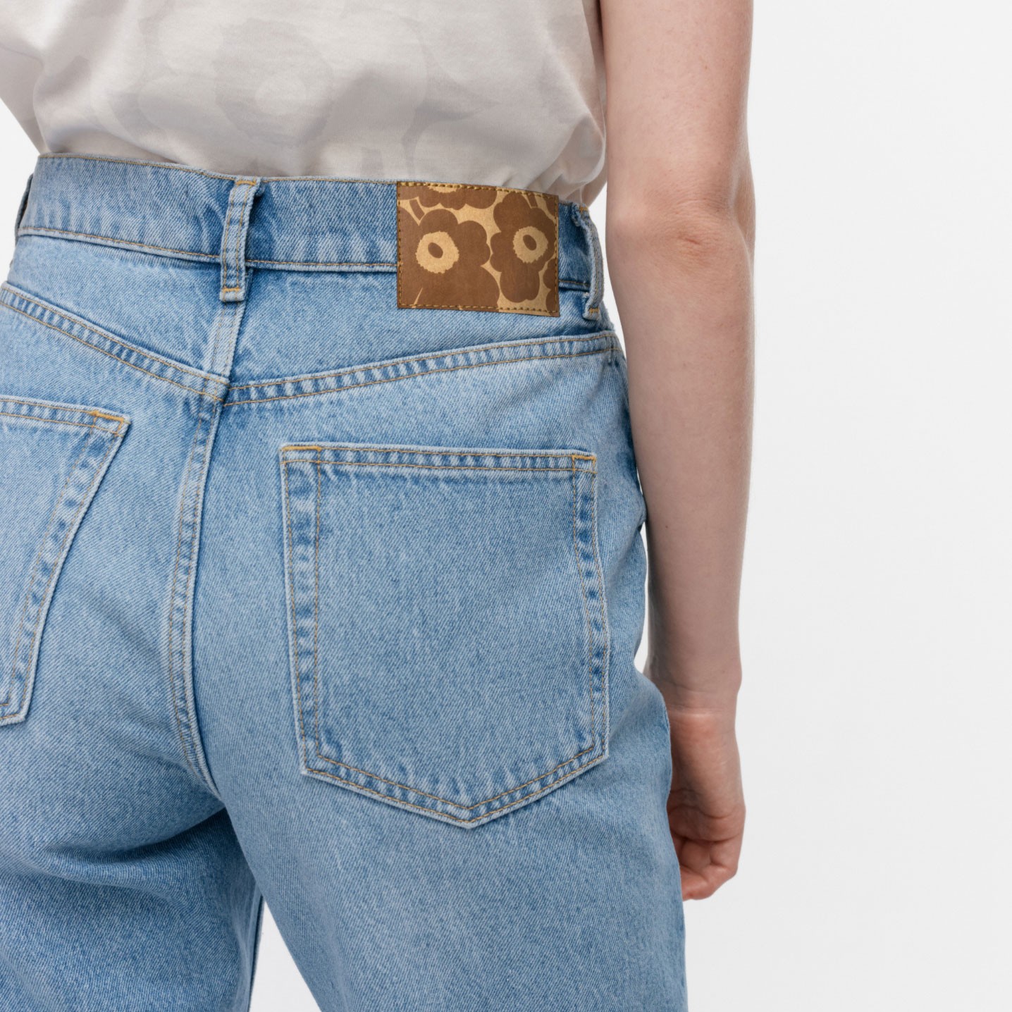 Model wearing light blue Marimekko Maridenim jeans shot from behind.