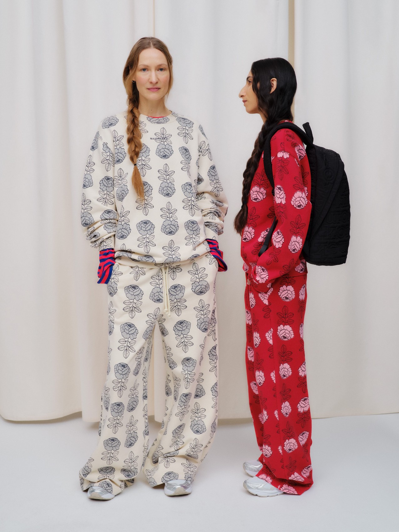 Models wearing Loisto and Leiot sweatshirts in Vihkiruusu print.