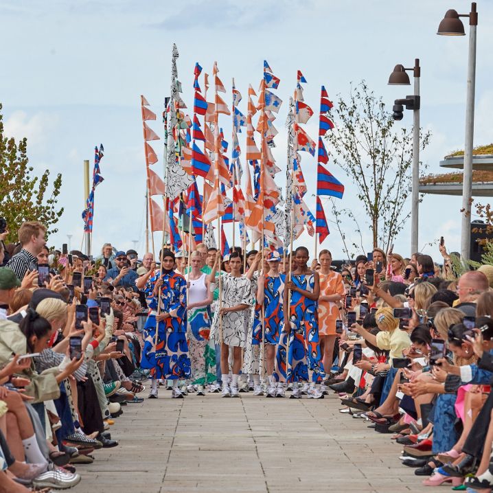 The models of the fashion show, dressed in Marimekko's colorful clothes in front of the audience, carried flags with different Marimekko patterns.