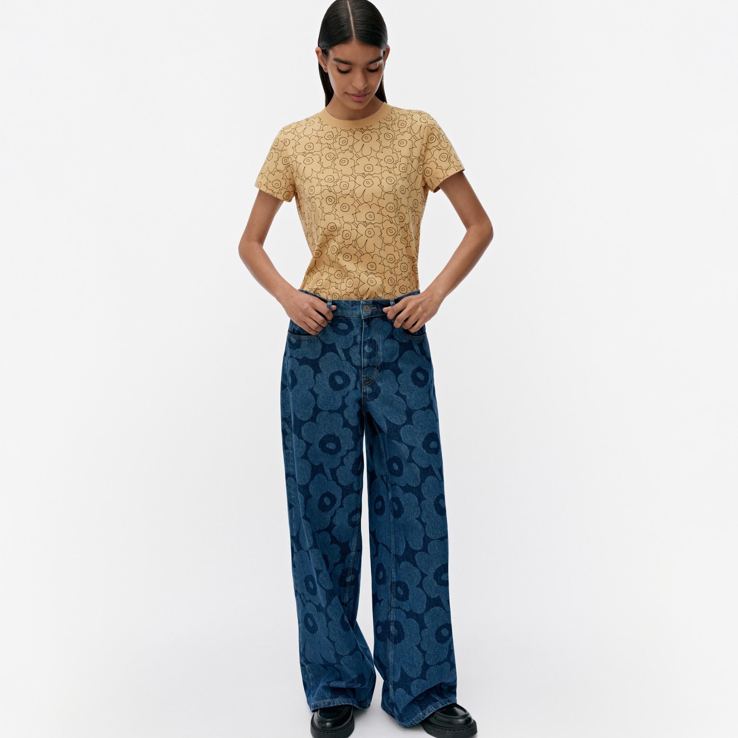 A model wearing Marimekko's Unikko-printed Maridenim jeans