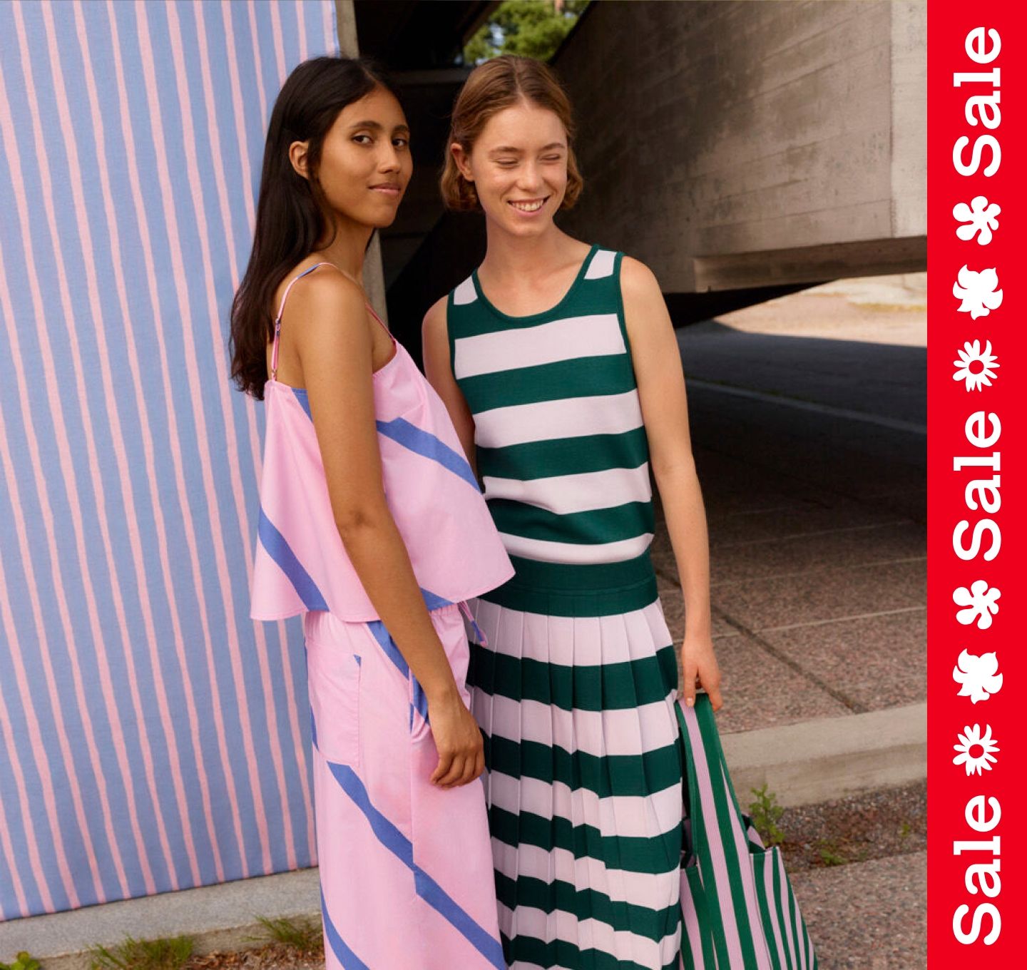 Two models wearing sets in Basso and Raita prints. On the side a vertical textline ''Sale''