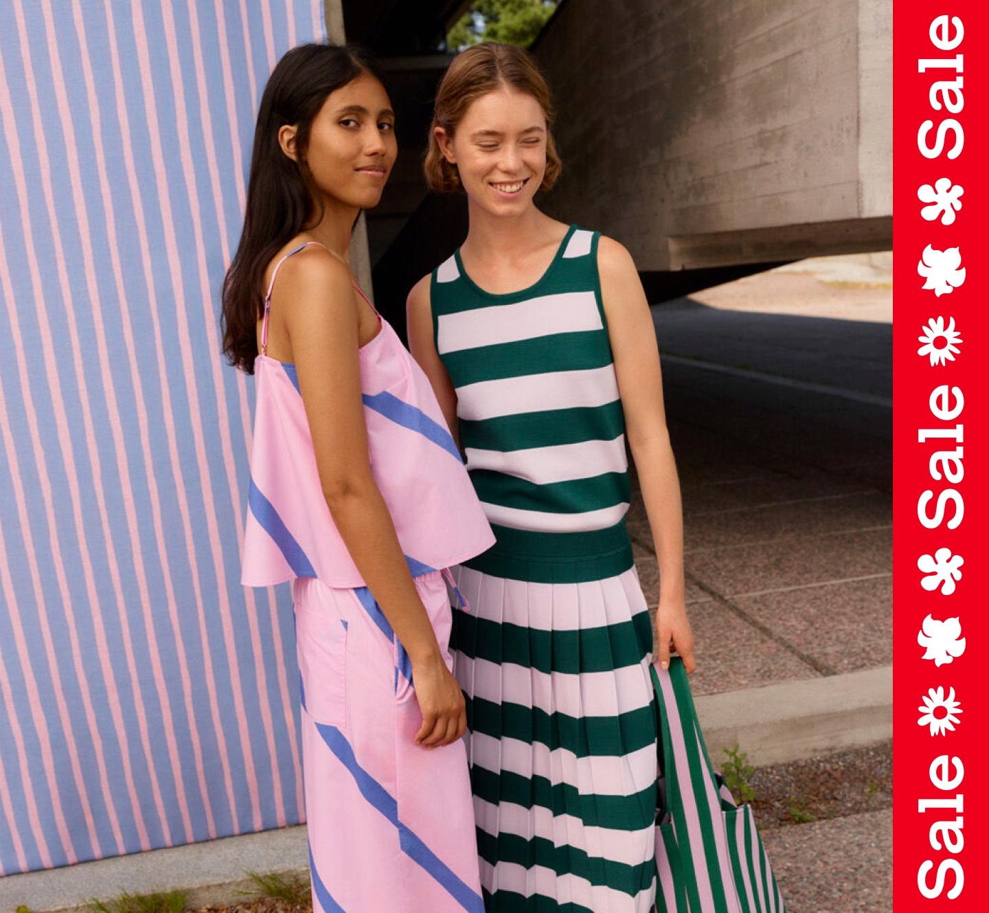 Two models wearing sets in Basso and Raita prints. On the side a vertical textline ''Sale''