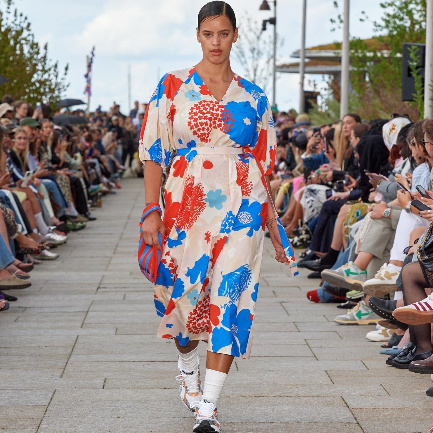 Model walking on the catwalk of the fashion show dressed in Kimppu Suvikimppu dress.
