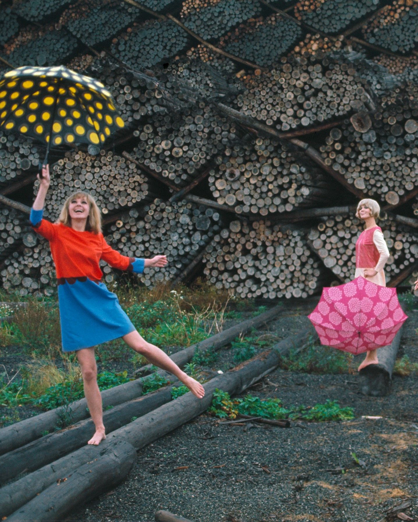 Photo by Tony Vaccaro of two models wearing Marimekko clothing and holding umbrellas.