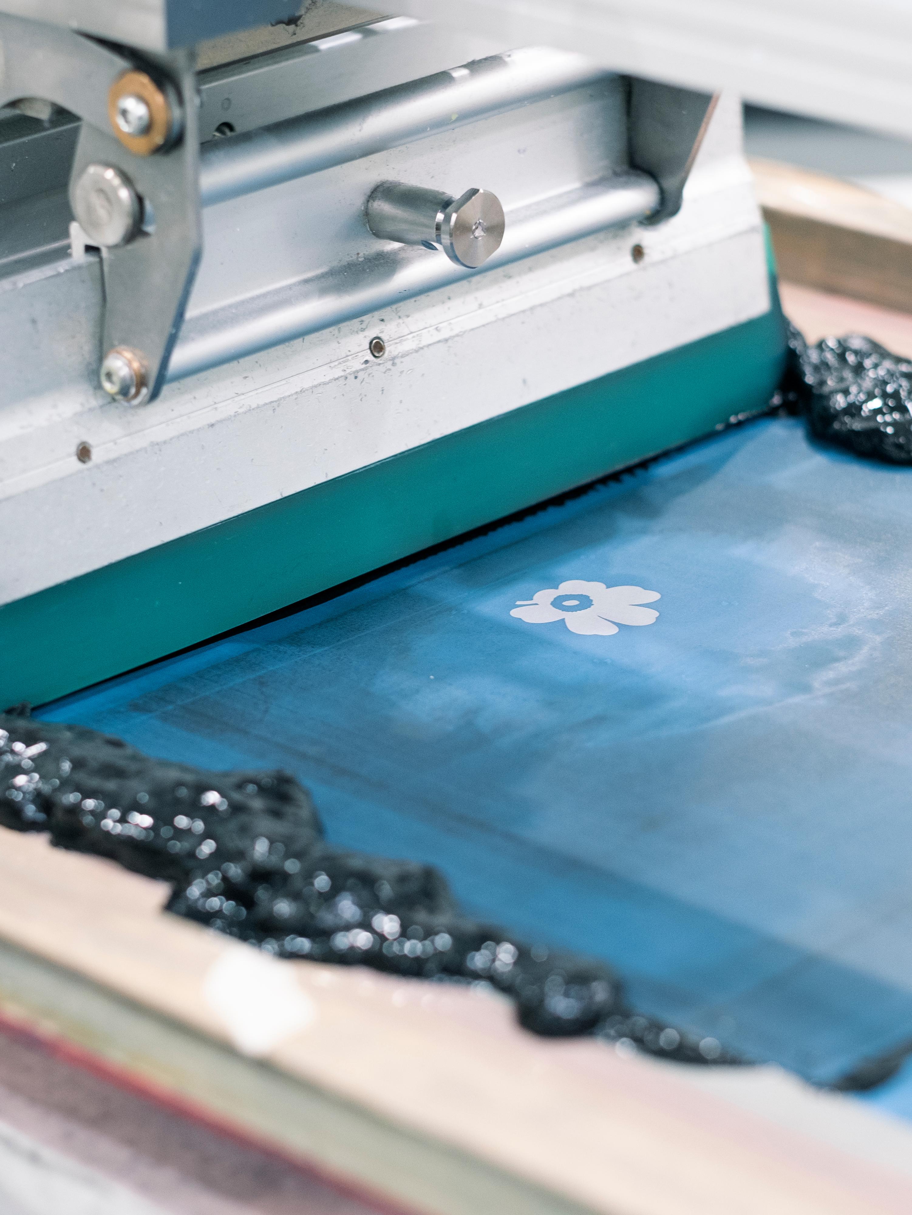 Unikko being printed on fabric.