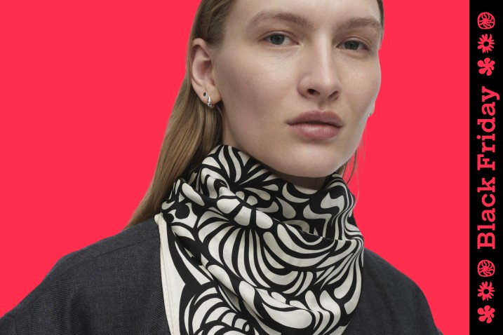 Woman wearing black and white scarf around neck. Image with Black Friday stripe down the right hand side of the frame