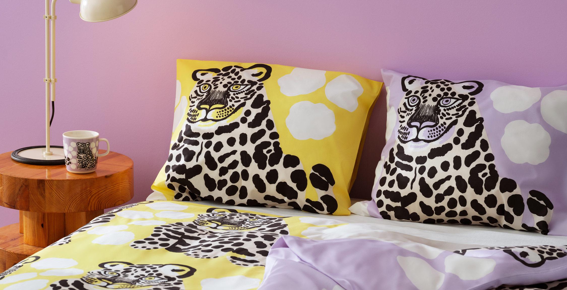 Un lit fait avec des draps à imprimé Kaksoset jaunes et lilas.