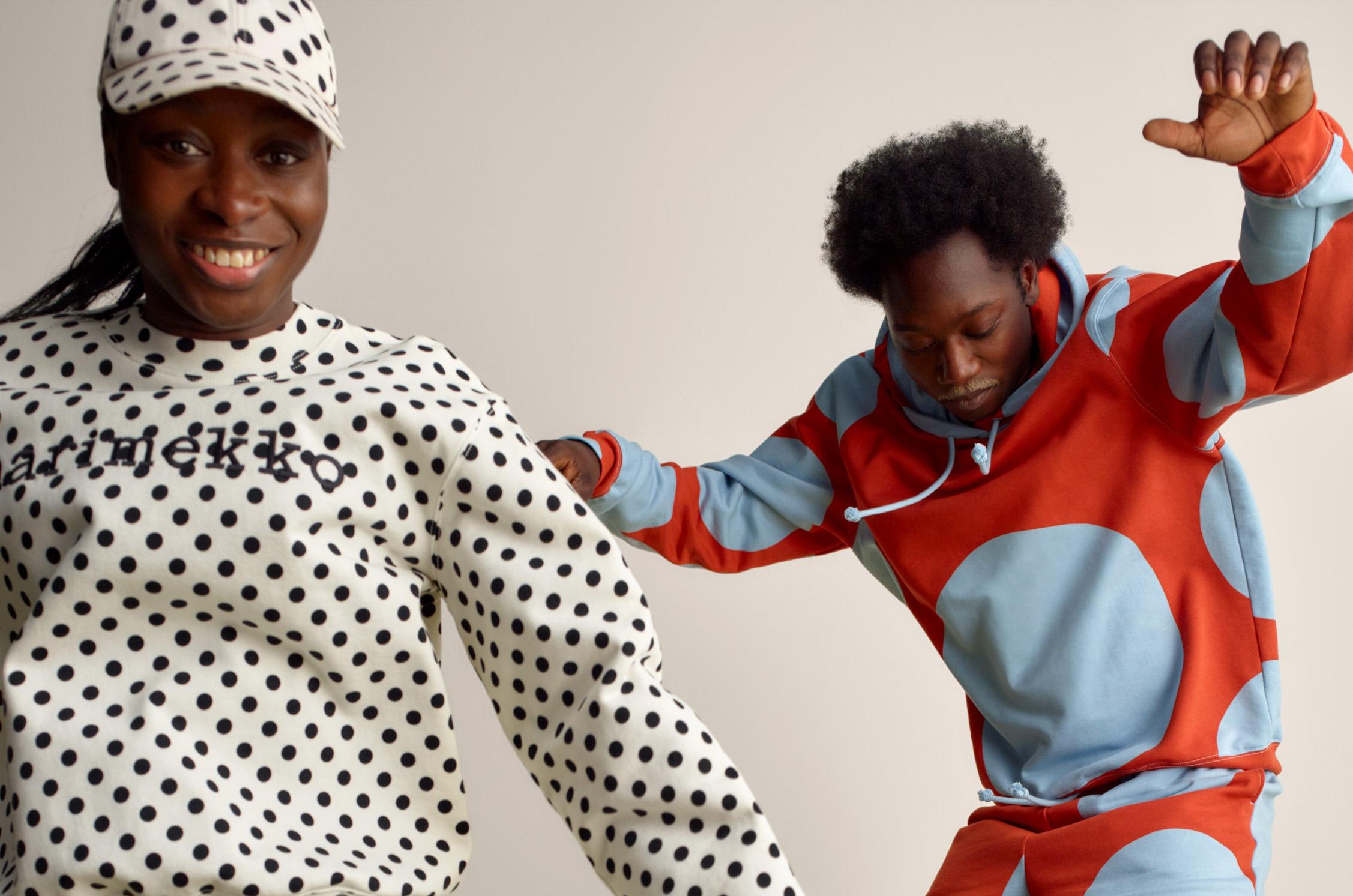 Two happy models jumping and wearing Marimekko Kioski sets in Pallo and Klaava prints.