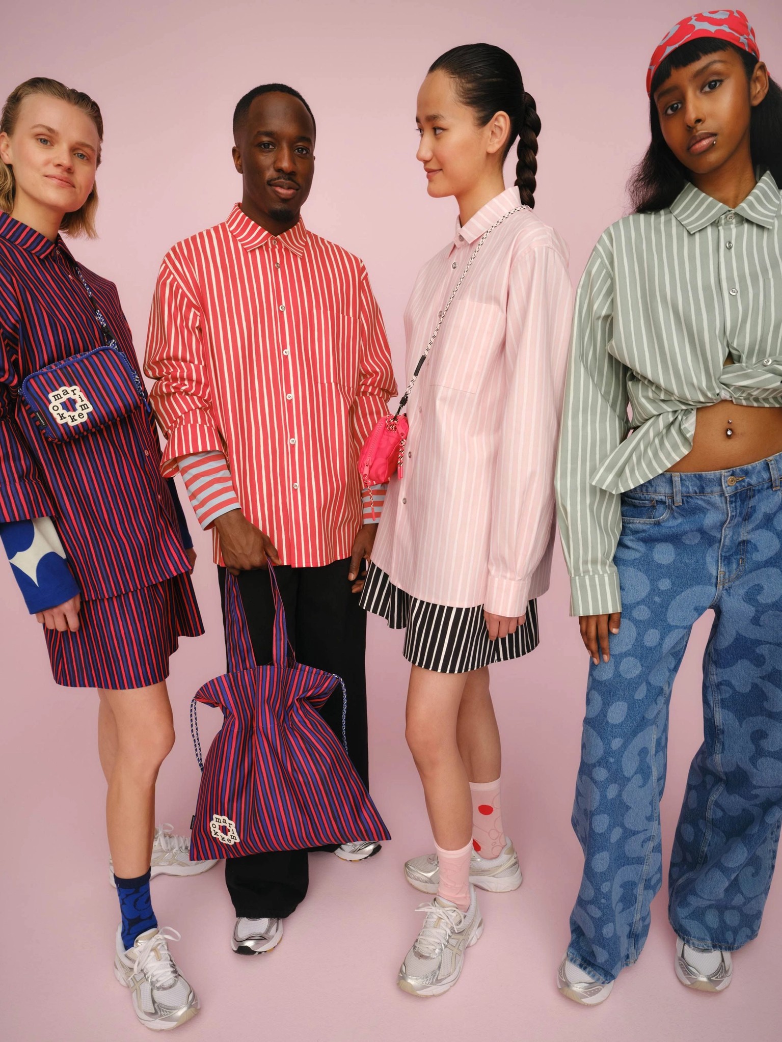 Four models wearing Marimekko Jokapoika shirts in joyful colors.