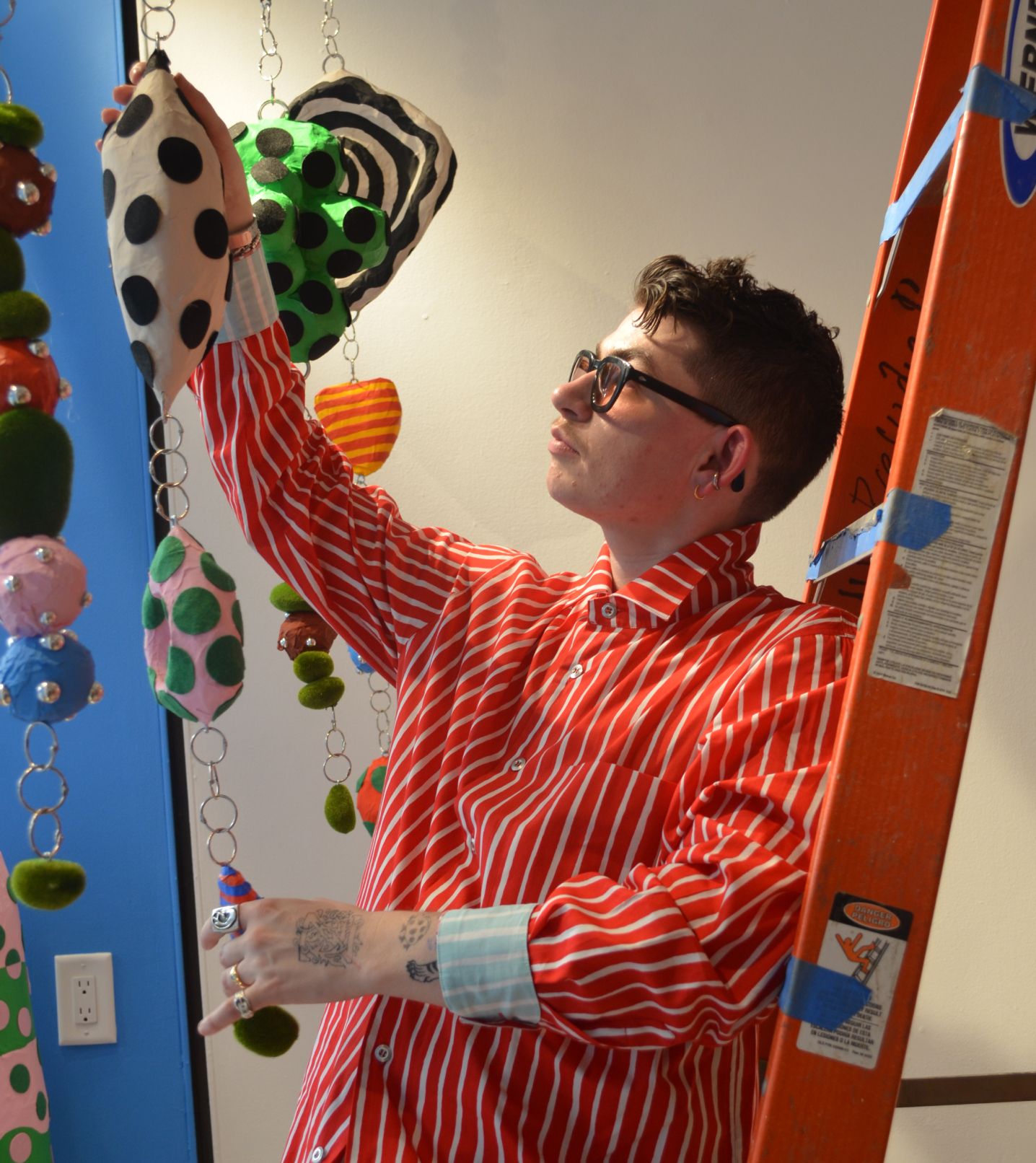 Zander Schlacter hanging his art on the window.